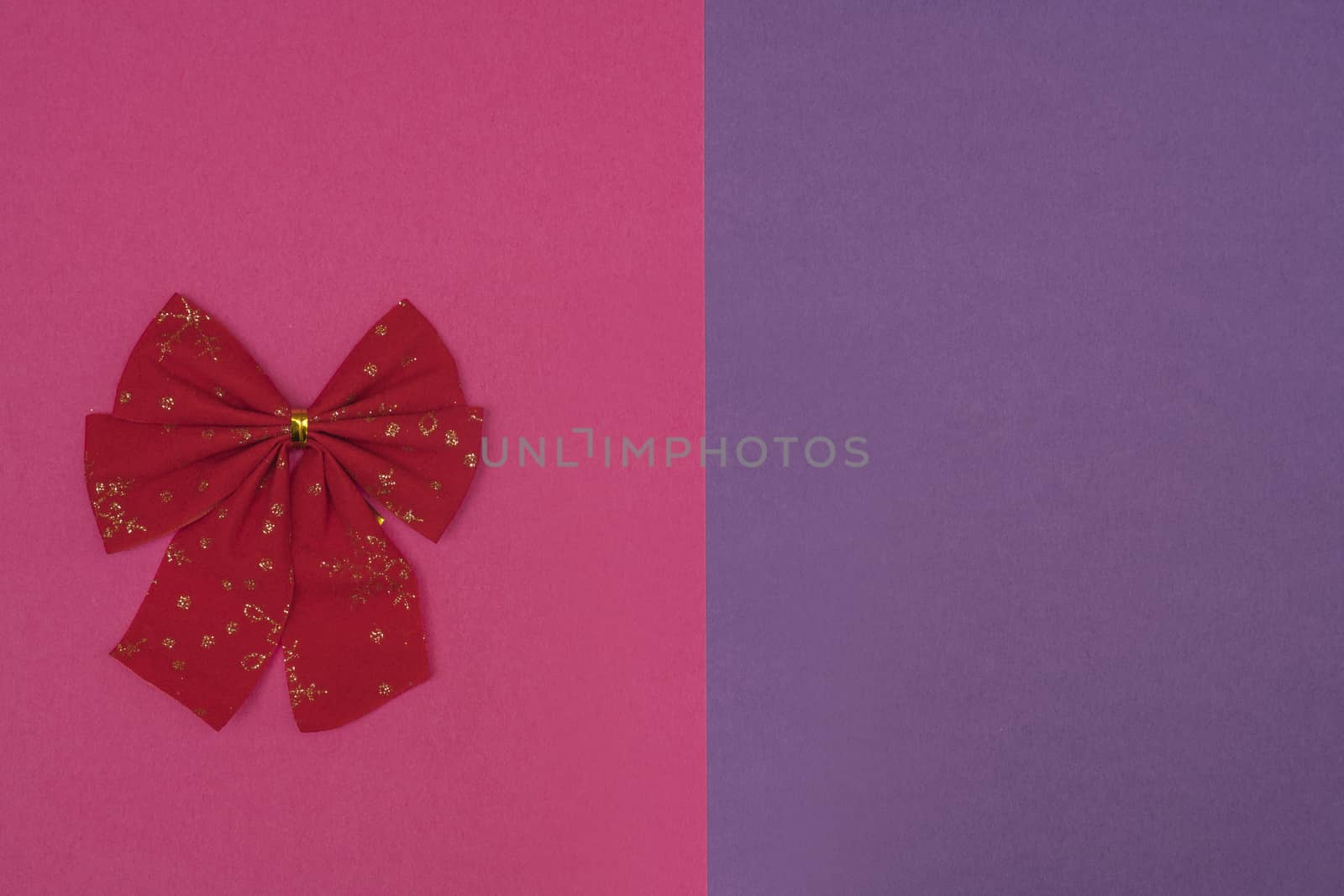 A decorative christmas bow on a colored background