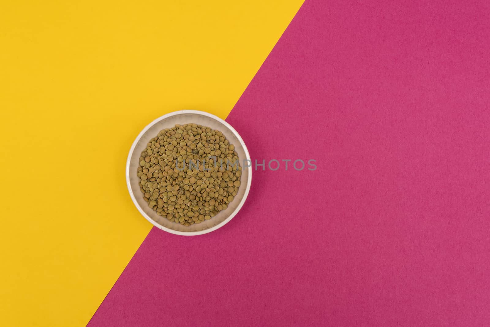 lentils in a bowl on a colored background
