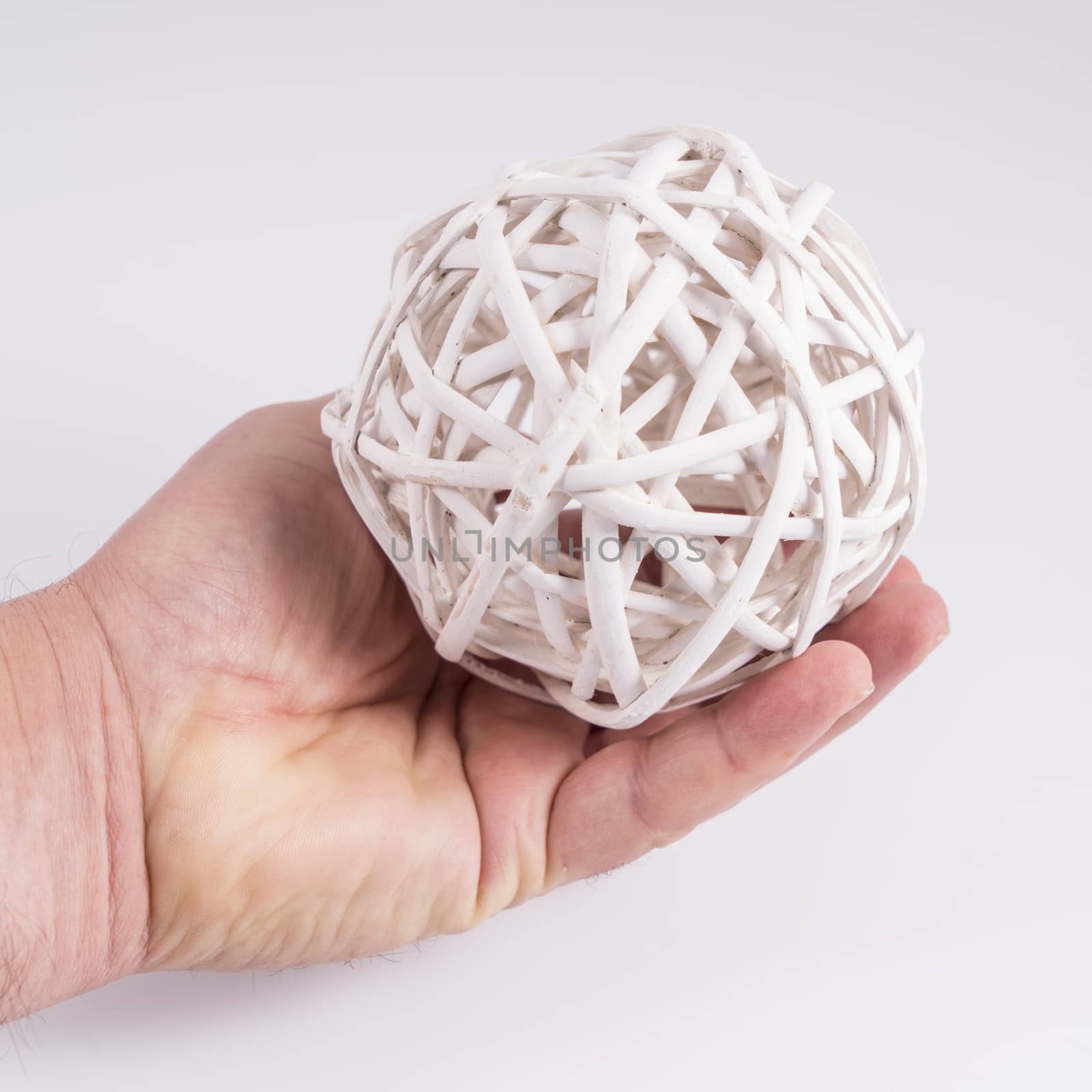 A ball made with white wooden slats on the hand
