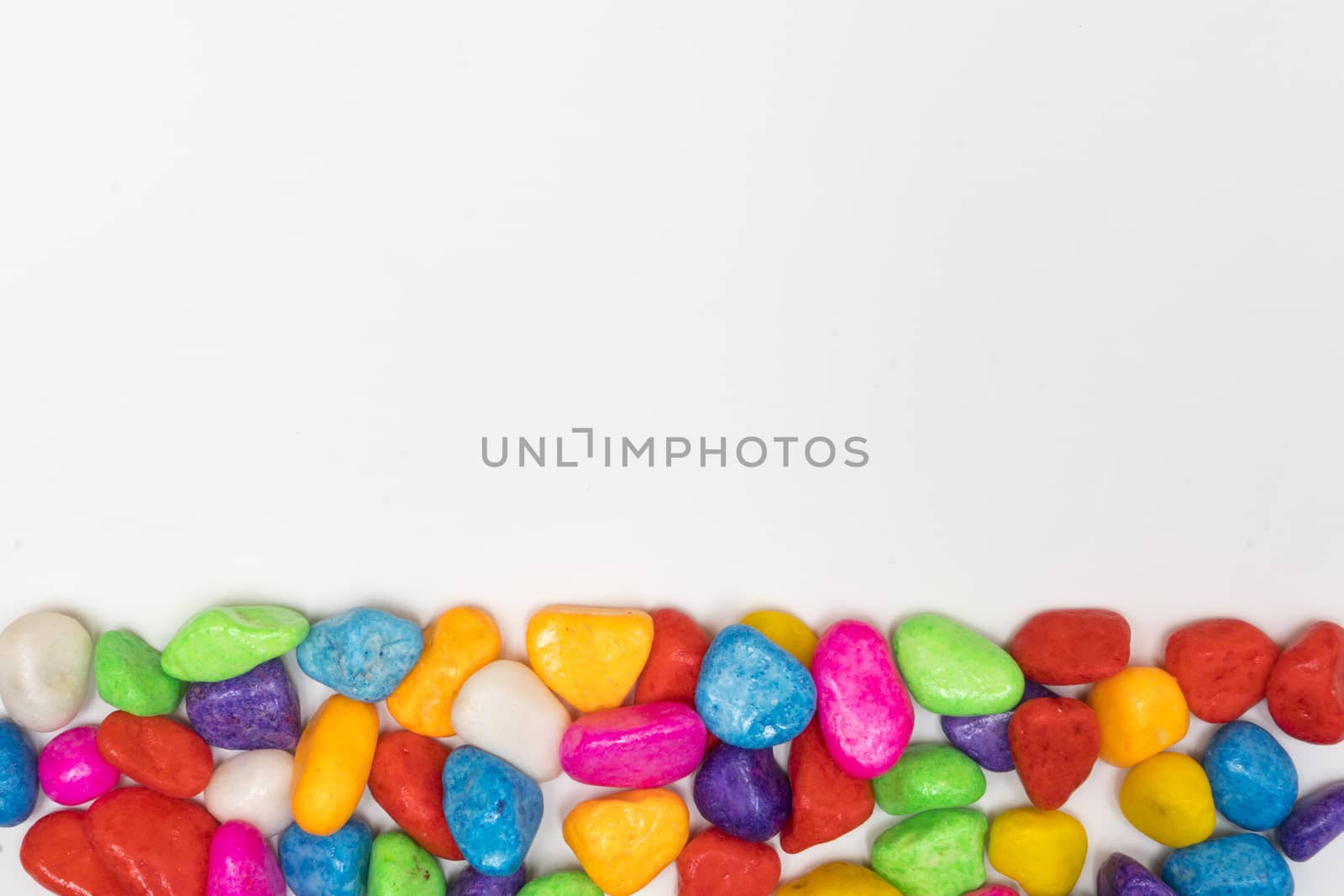 small colored pebbles on a white background