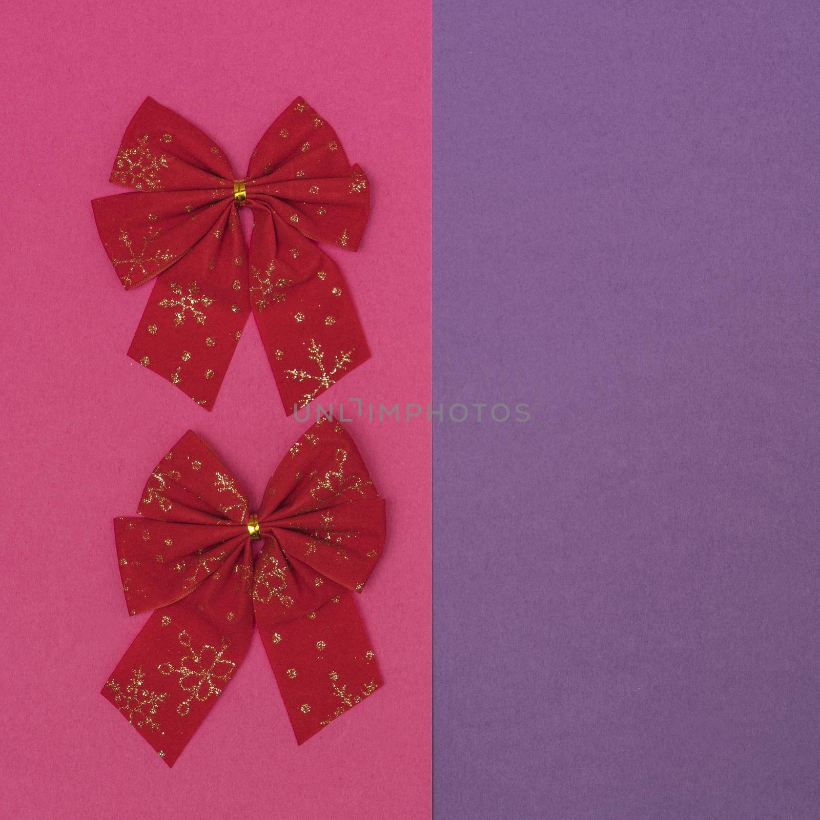 Christmas decorative red bows in a white frame on a colored background
