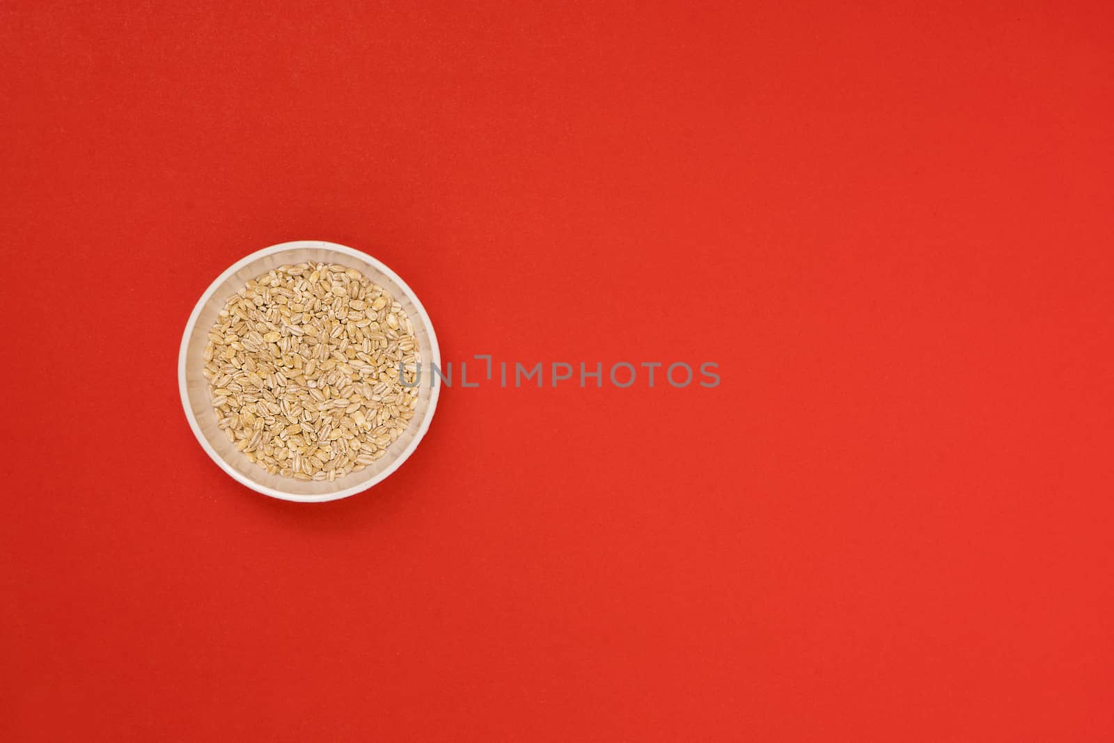 pearl barley a bowl on a colored background