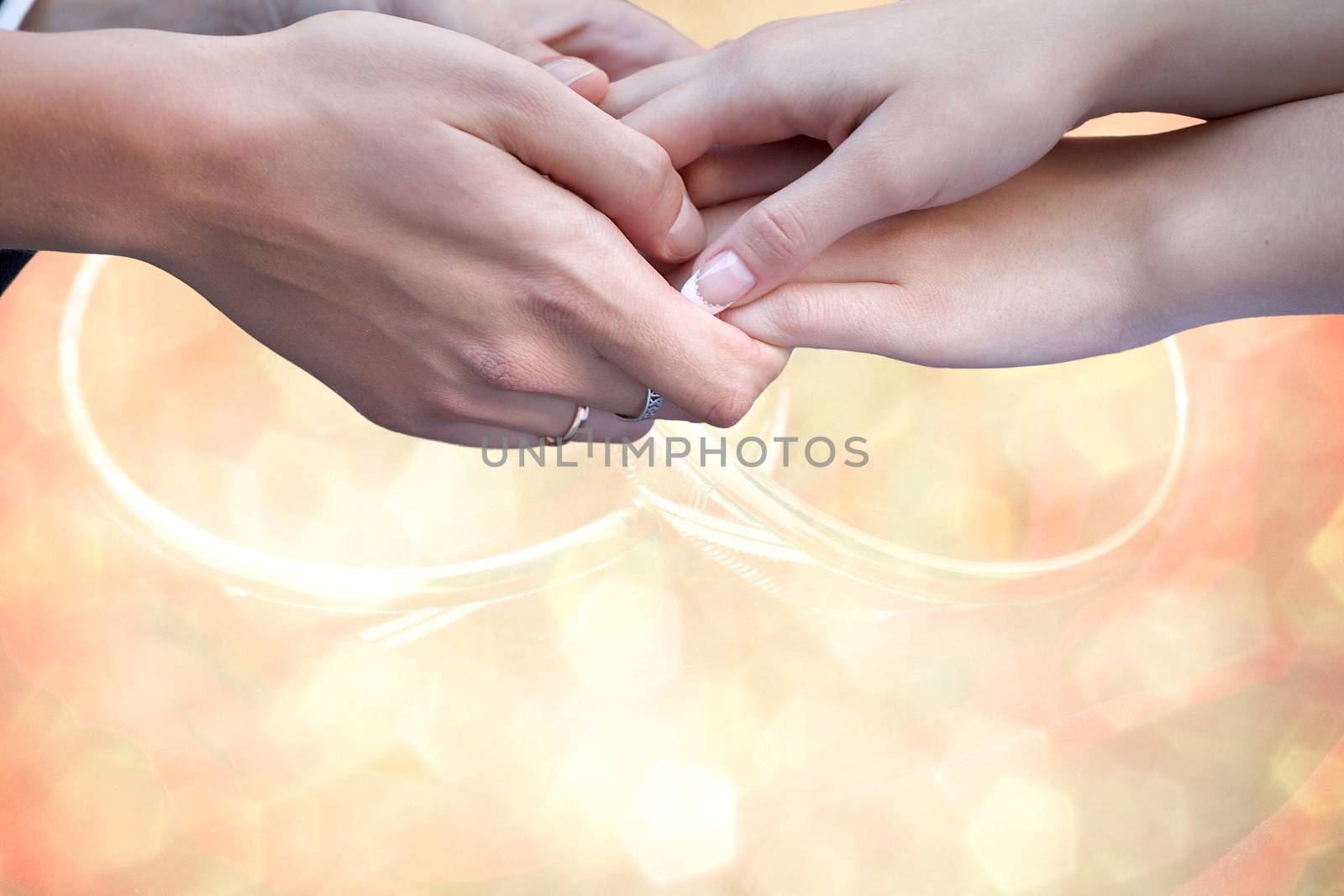 Young married couple holding hands, ceremony wedding day