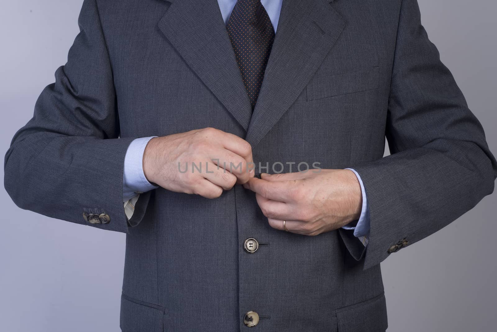 man buttoning his jacket