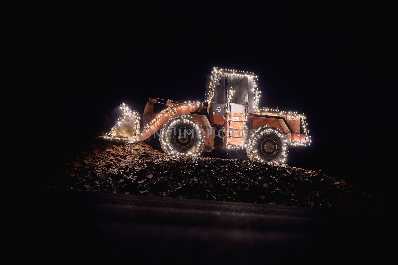 Blurred wheel loader decorated with lights bokeh lights on a wheel loader