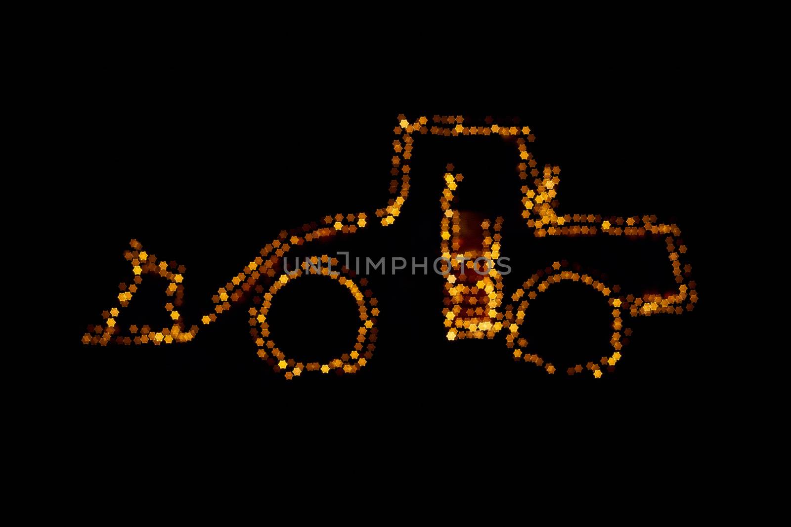 Blurred wheel loader decorated with lights star bokeh lights on a wheel loader