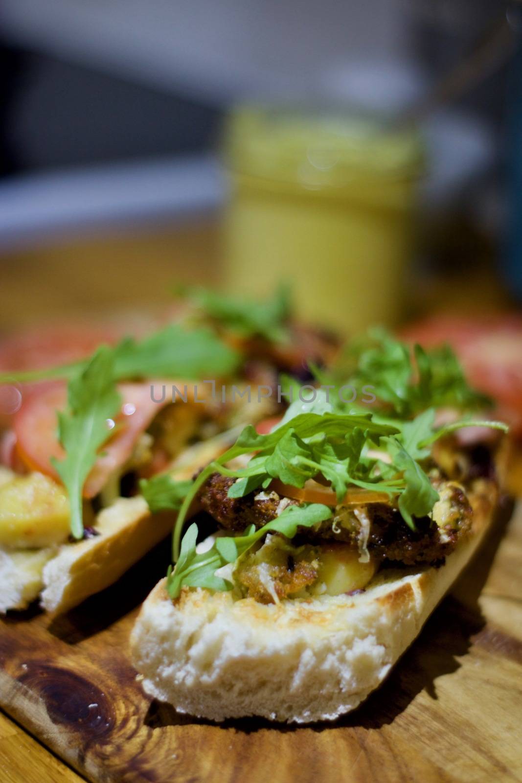 Delicious sandwich on the wooden board in the kitchen.