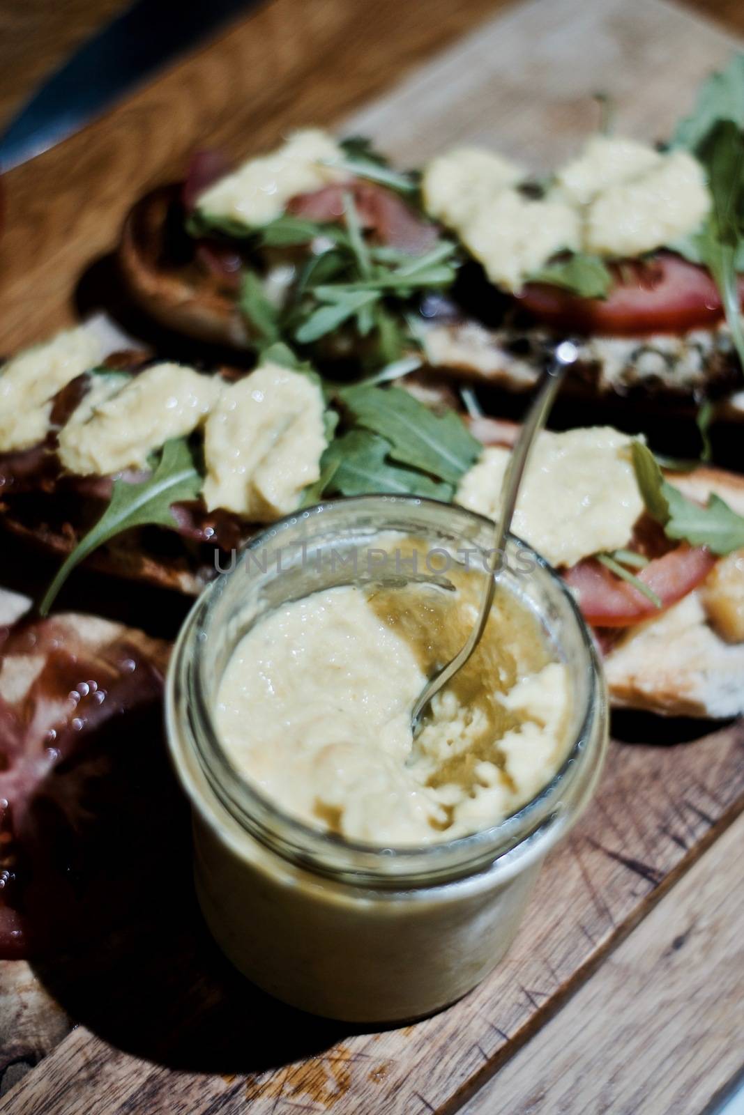 Delicious sandwich on the wooden board in the kitchen.