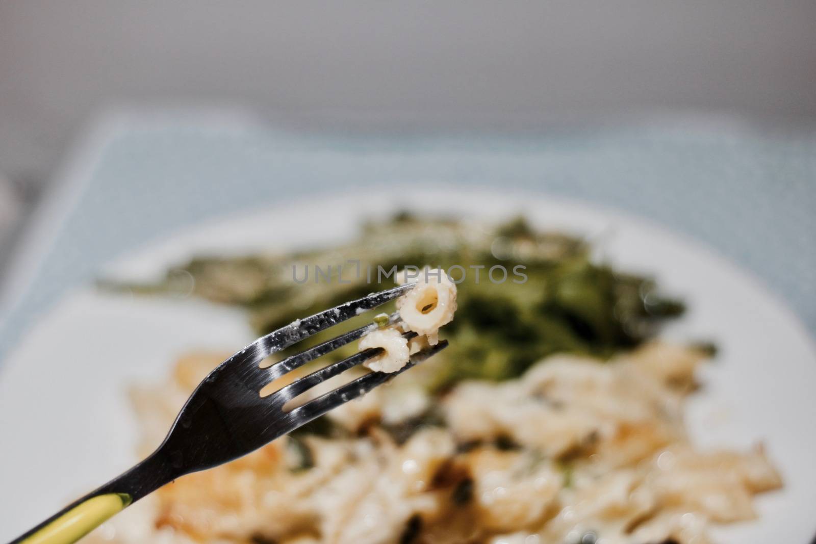 Delicious italian fresh pasta on a white plate in the kitchen. Food concept.