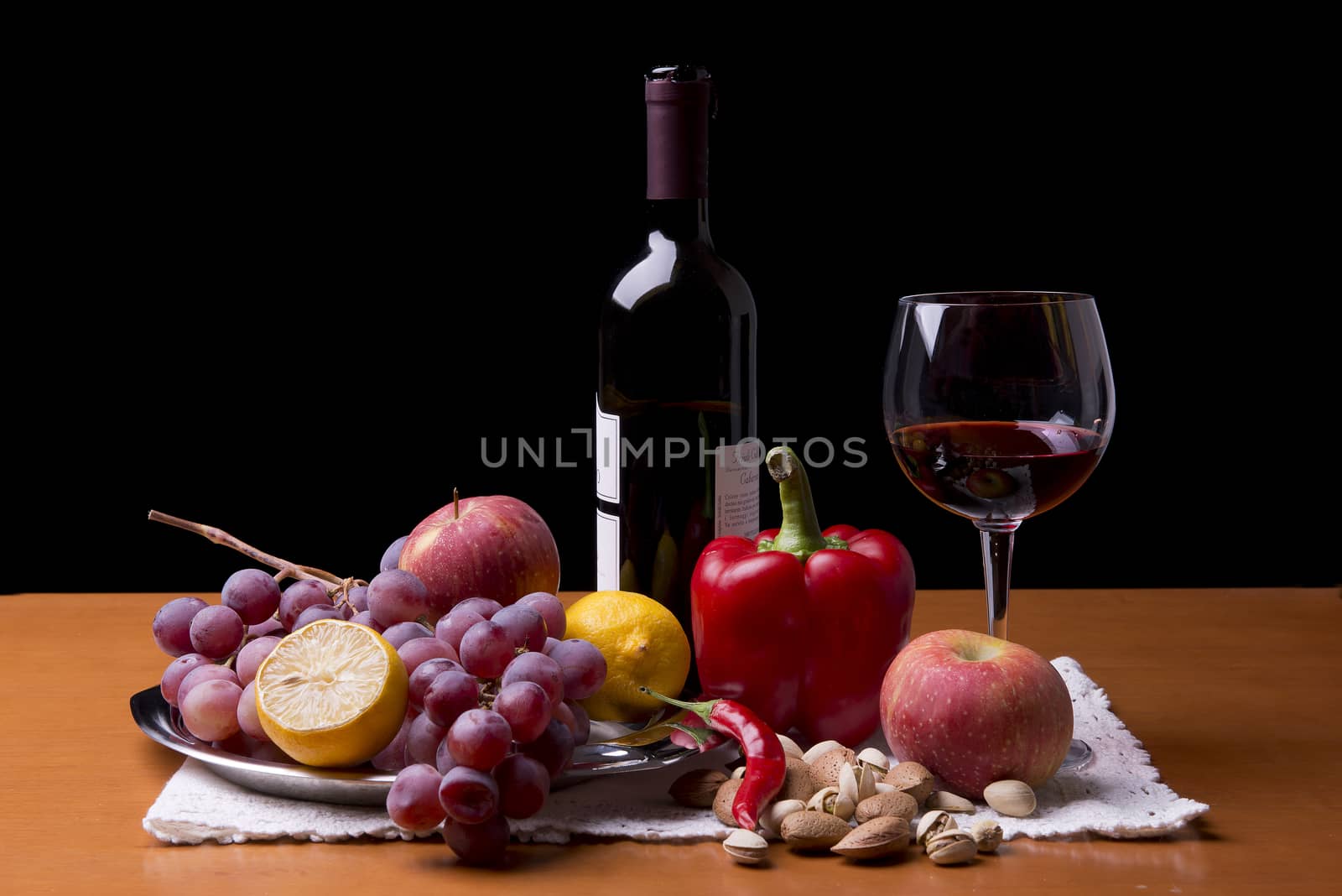 fruits, vegetables and a bottle of red wine on the table