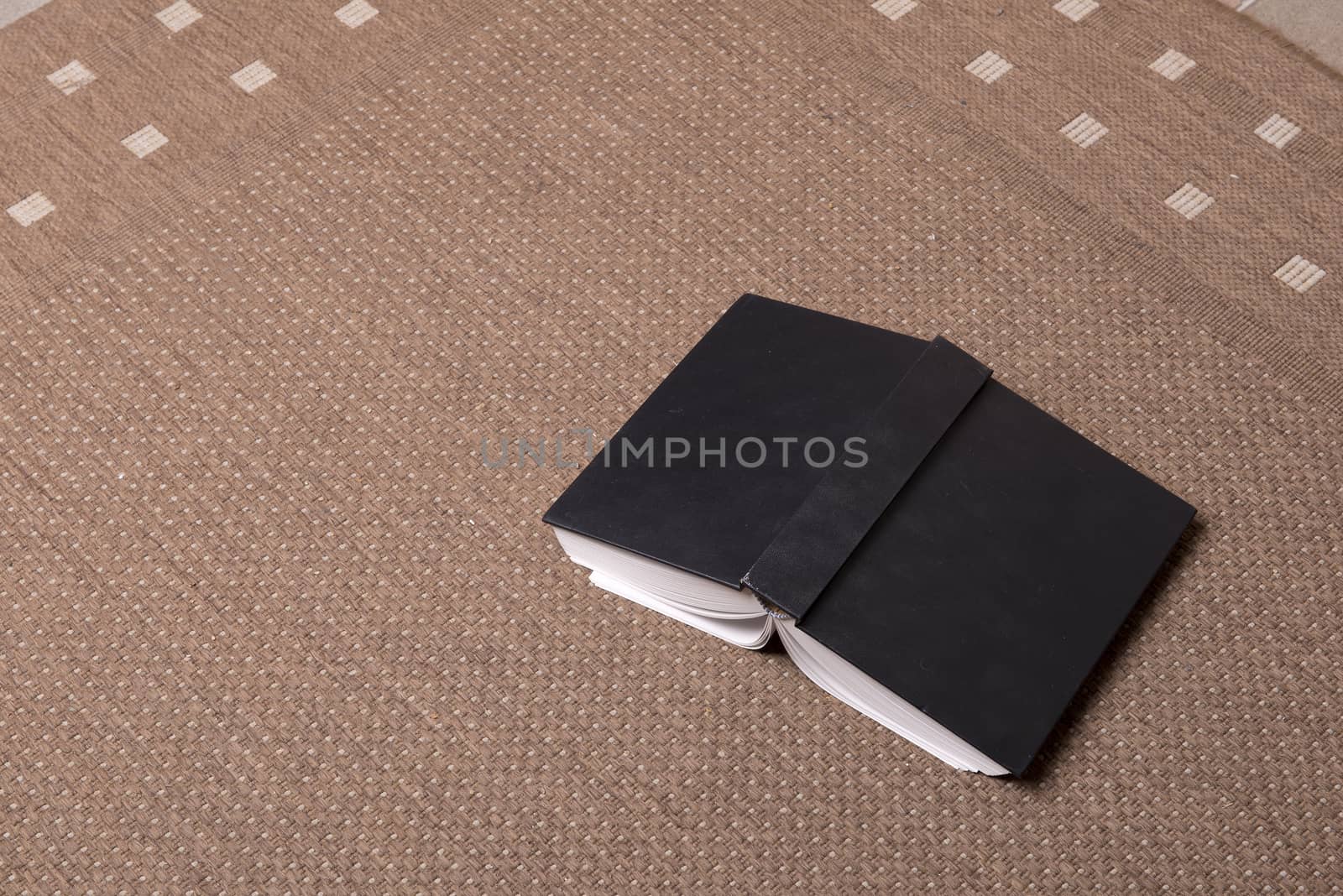 A book open on floor on the carpet