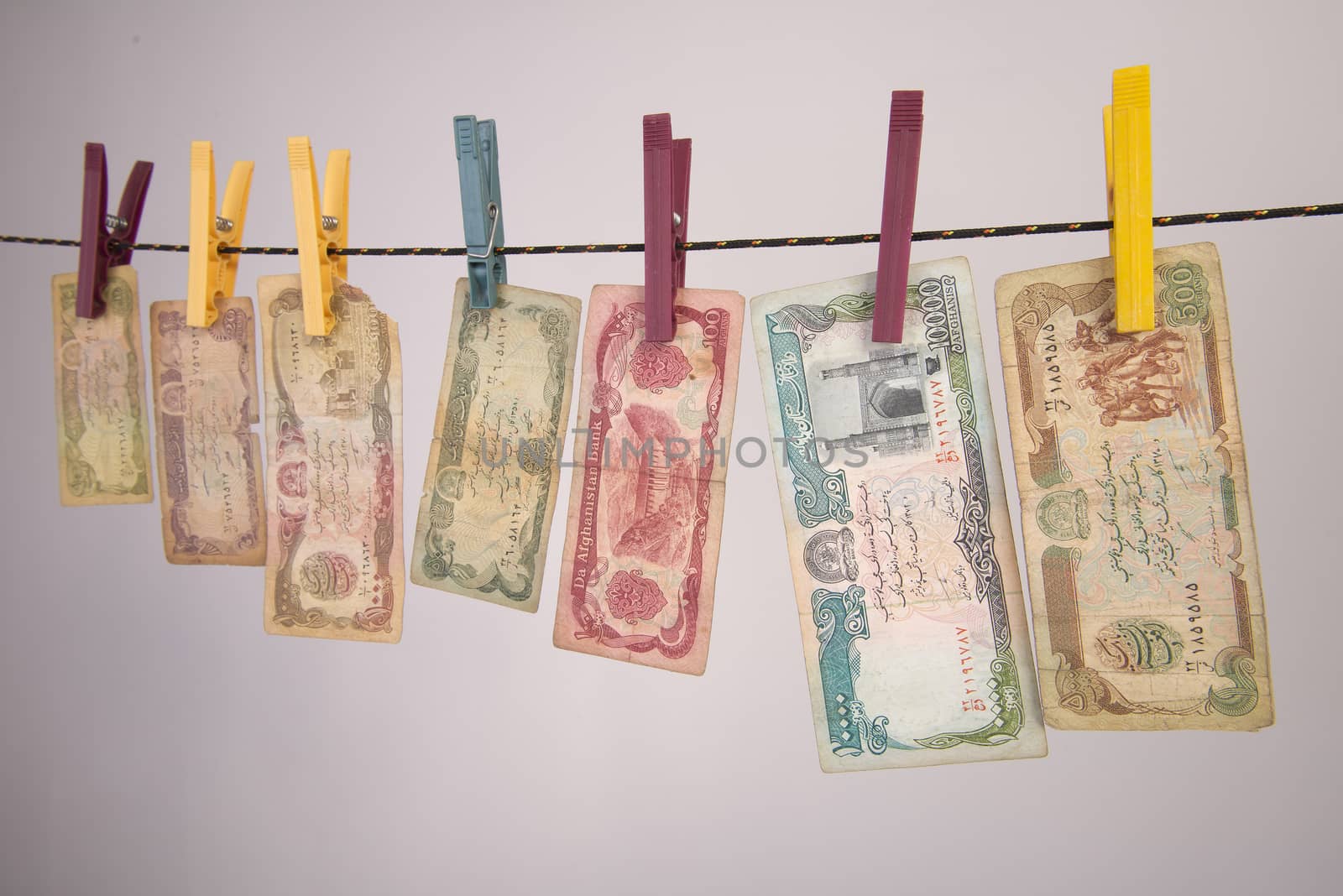 banknotes hung on a wire to dry