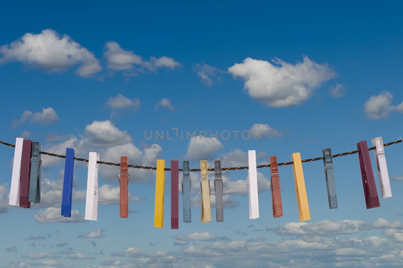 some colored clothespins on a thread to dry