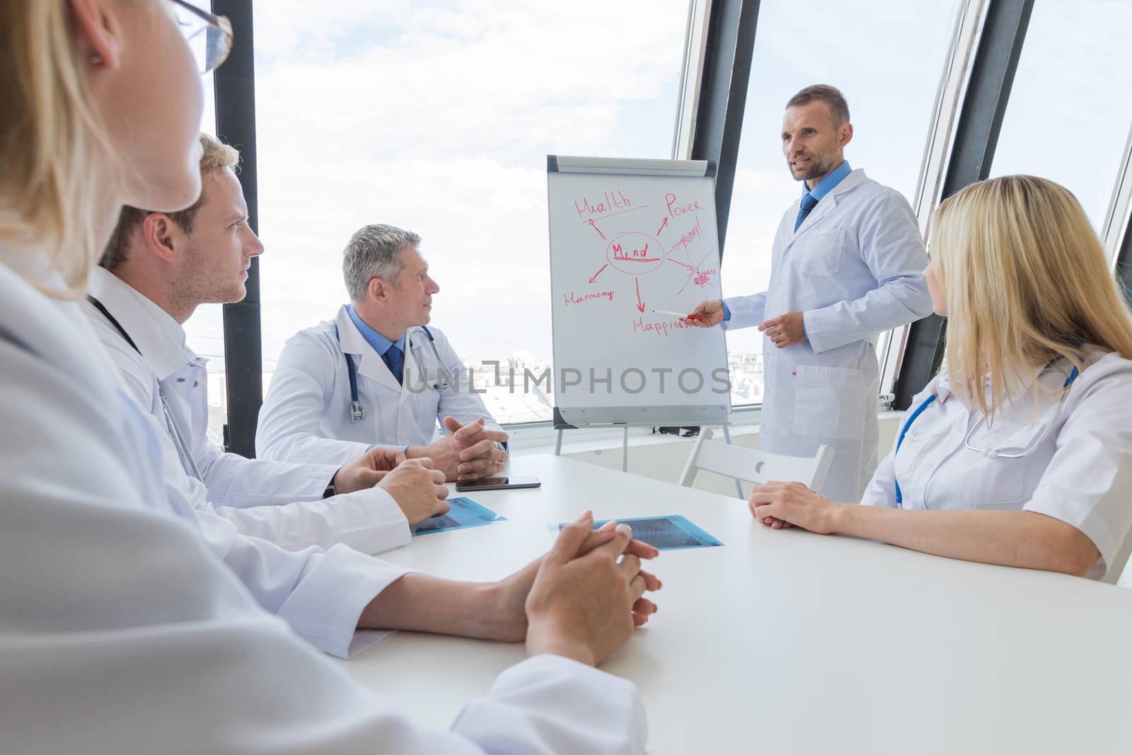 Team of doctors listening mental health conceptual presentation in clinical office