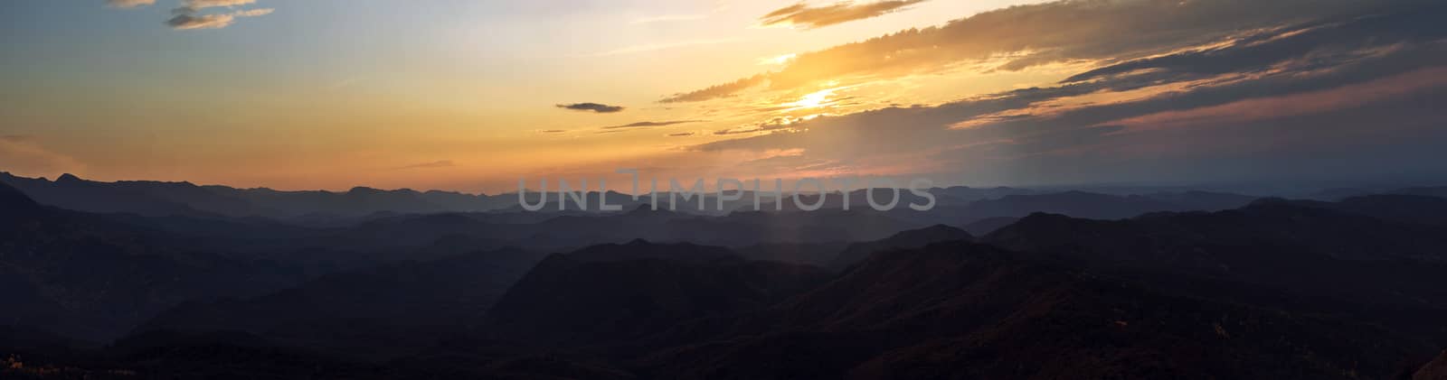 Panorama. Sunset sky above the autumn mountains.