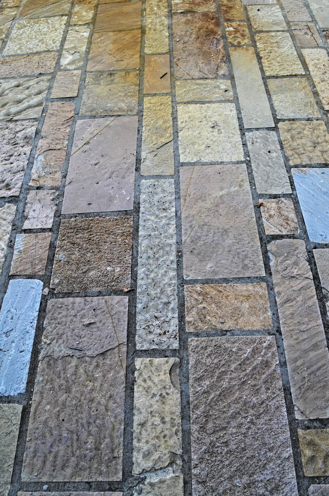 Decorated bricks tiles sidewalk, close up by sheriffkule
