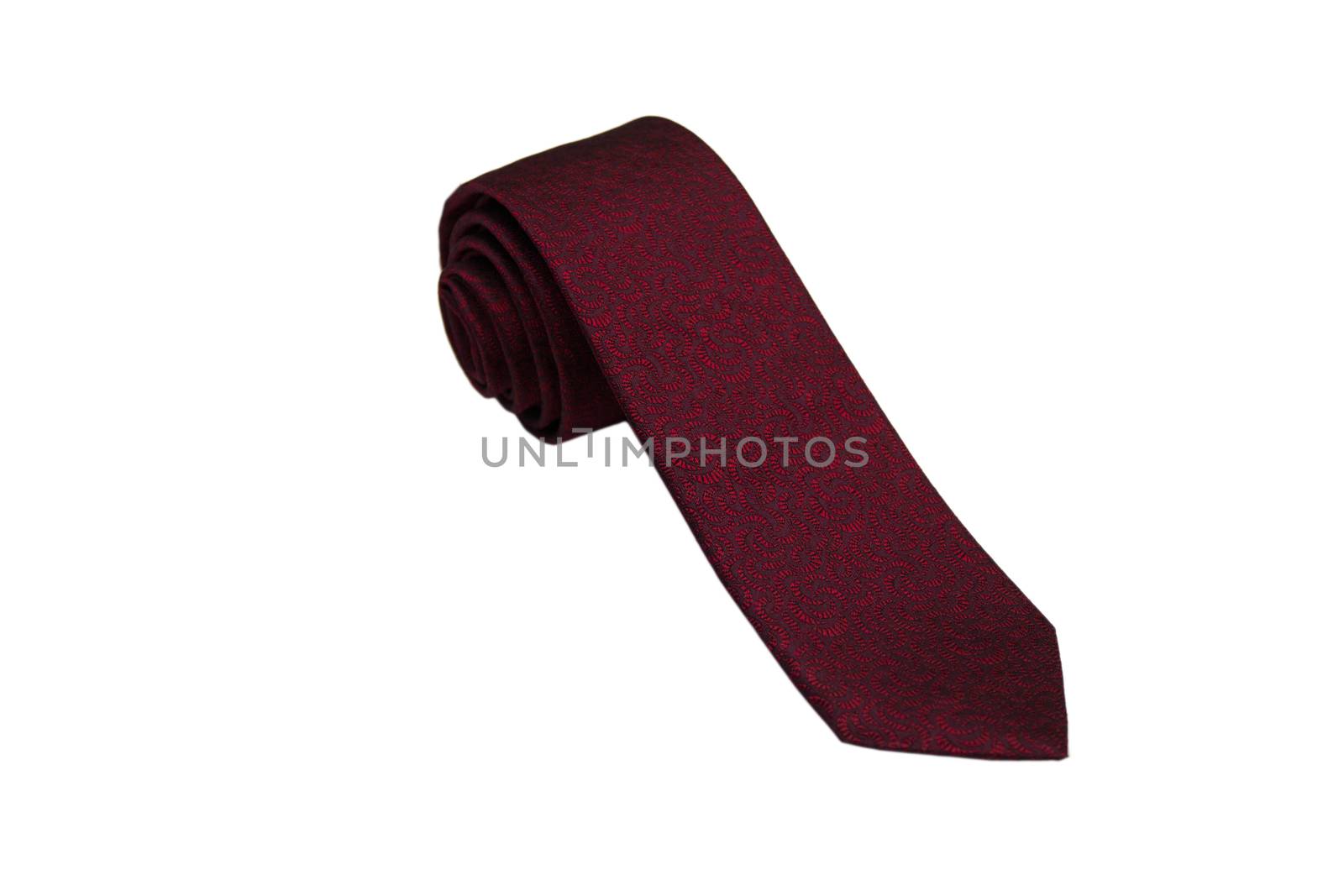 Closeup of an elegant stylish tie rolled and isolated on a white background.