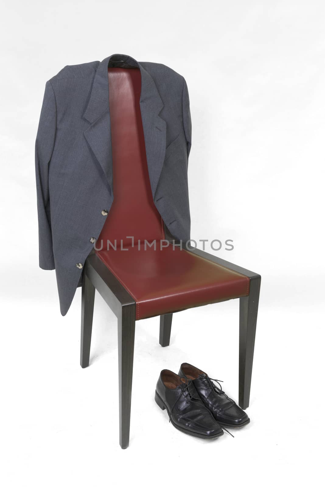 A jacket and a pair of shoes with a red chair