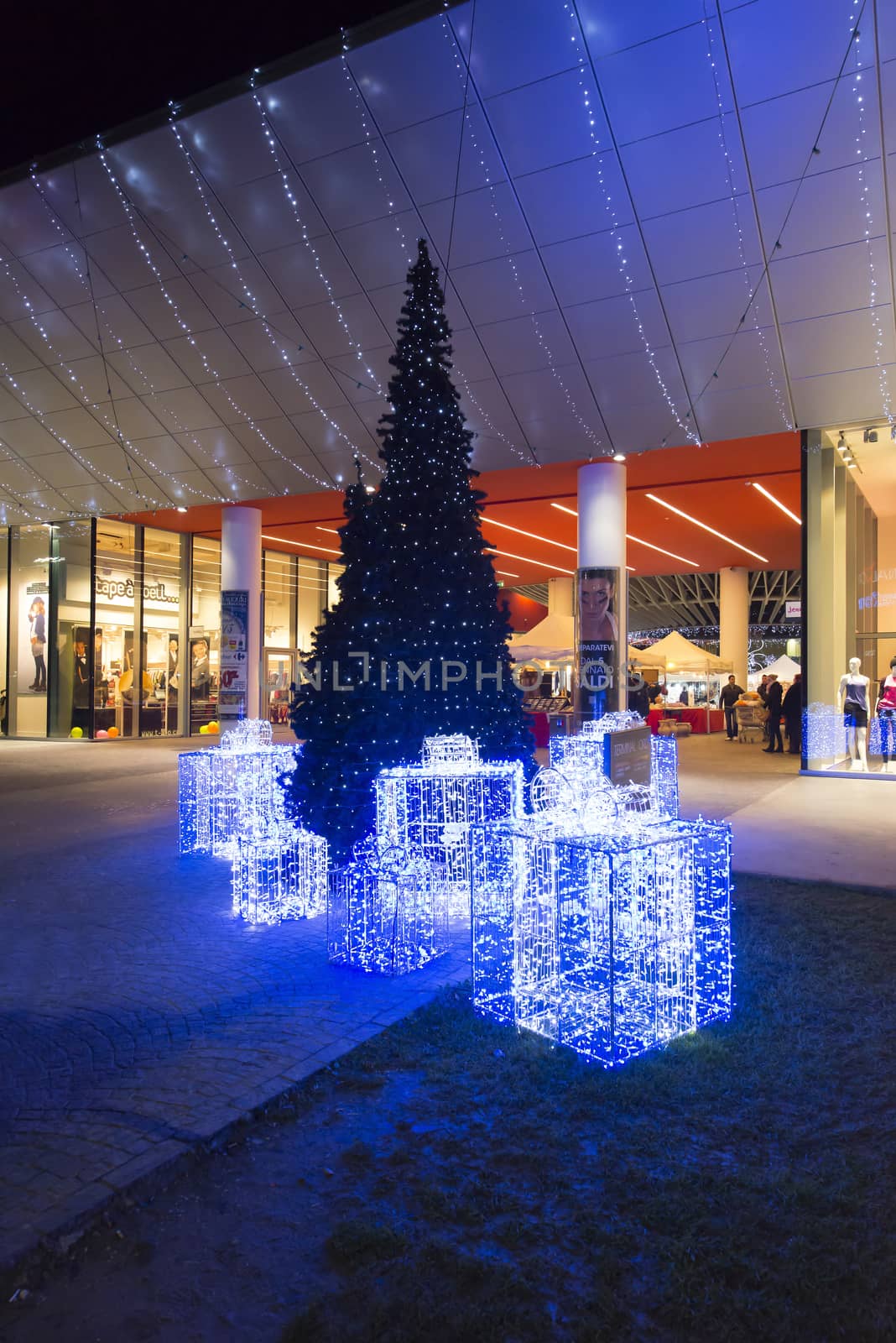 bright Christmas recourse lit up in front of a shopping mall