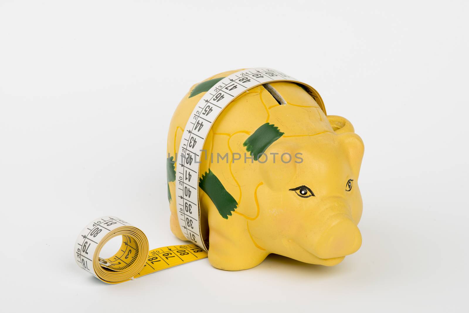 a piggy bank wrapped by a tape measure