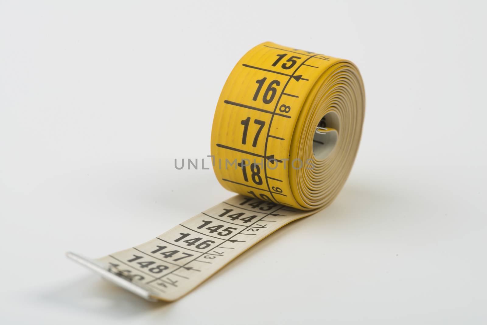 a yellow tape measure rolled up