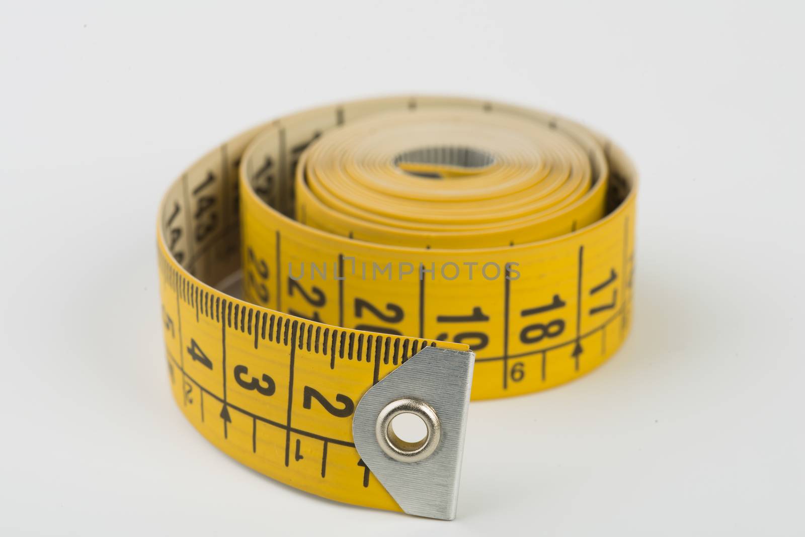 a yellow tape measure rolled up