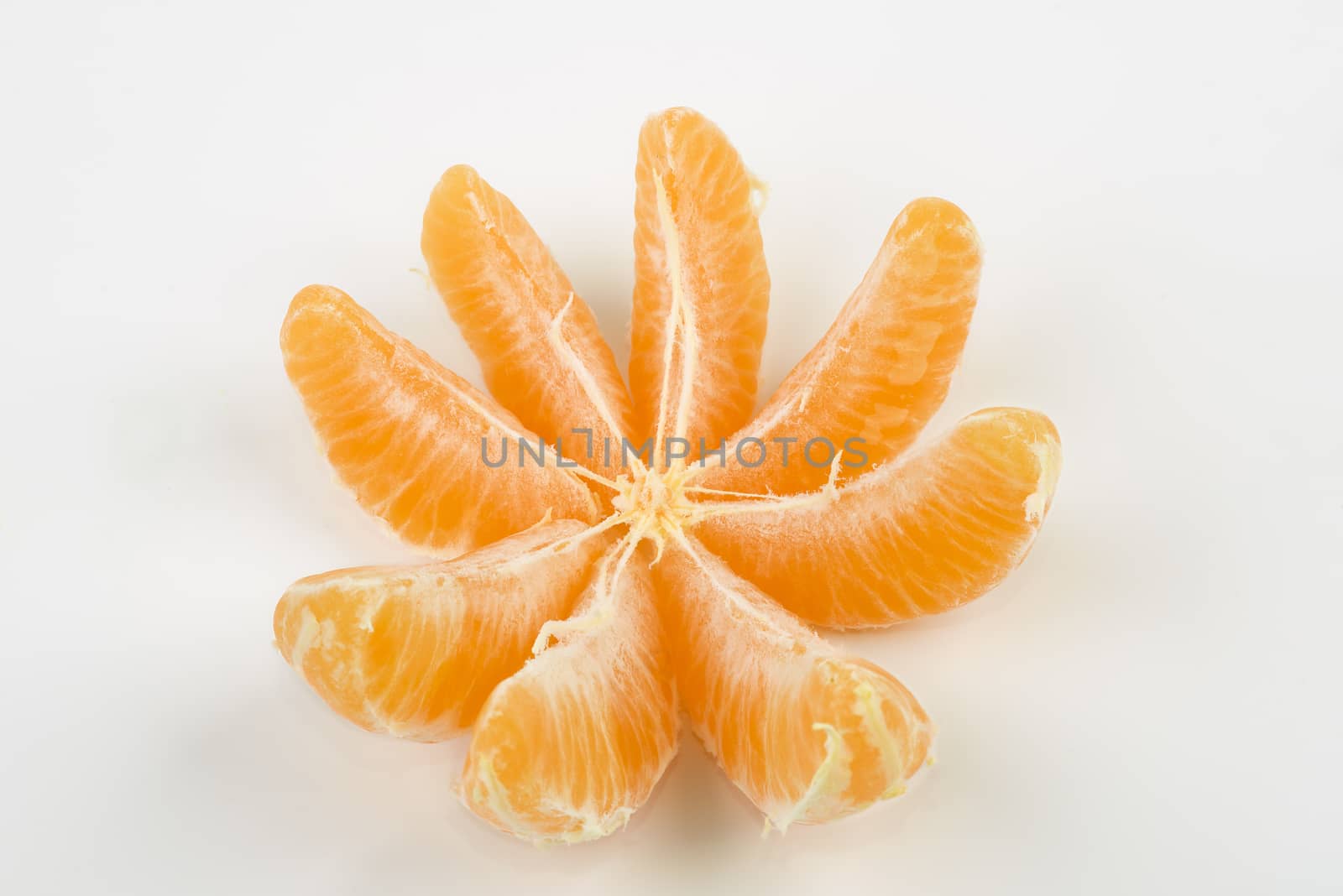 a peeled tangerine on a white table