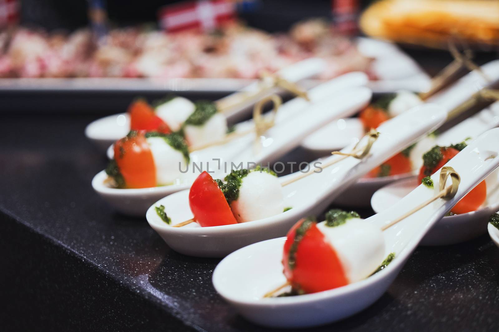 Mozzarella and tomatoes. Dark grey background by 3KStudio