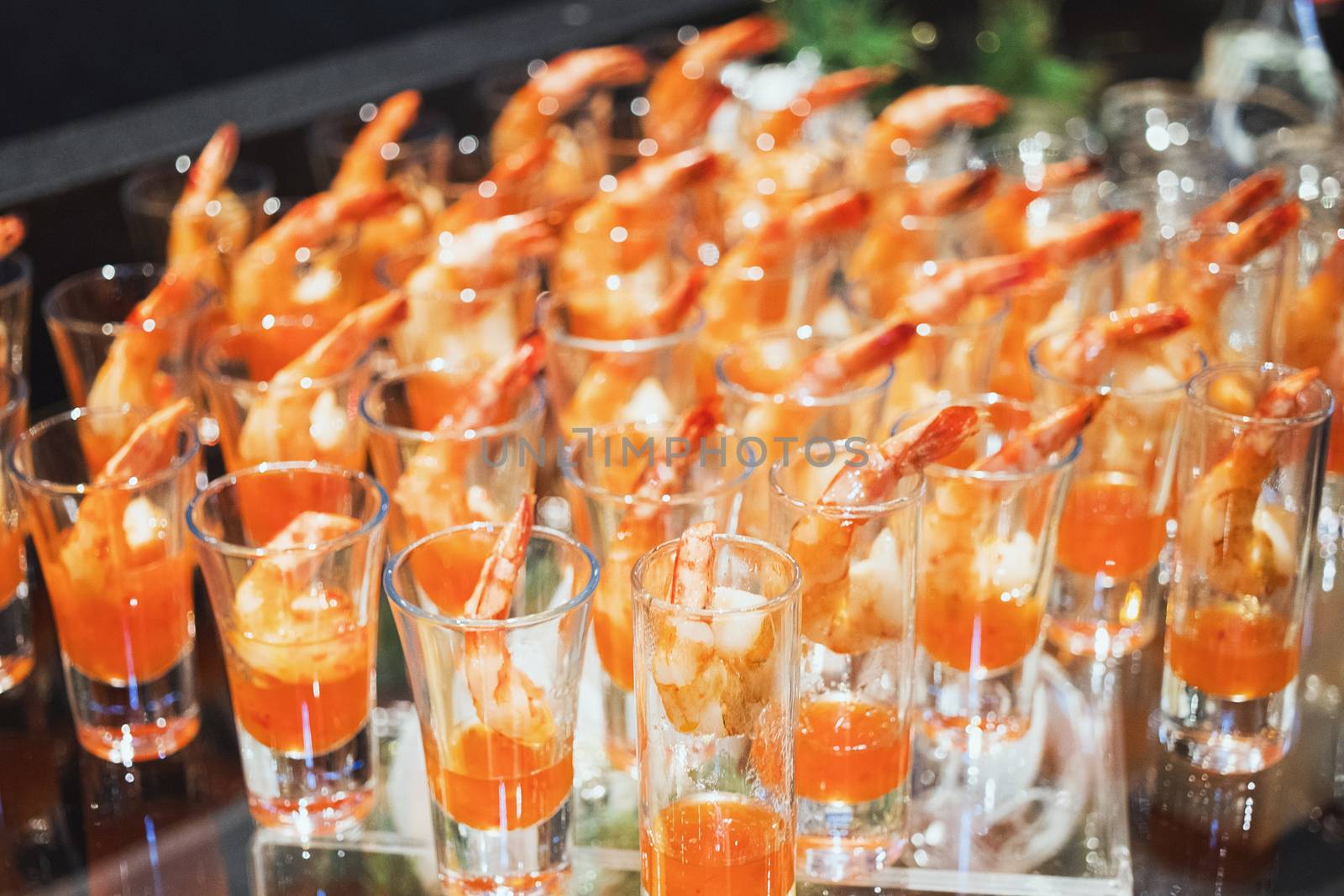 Shrimp cocktail in shot glass shot closeup.