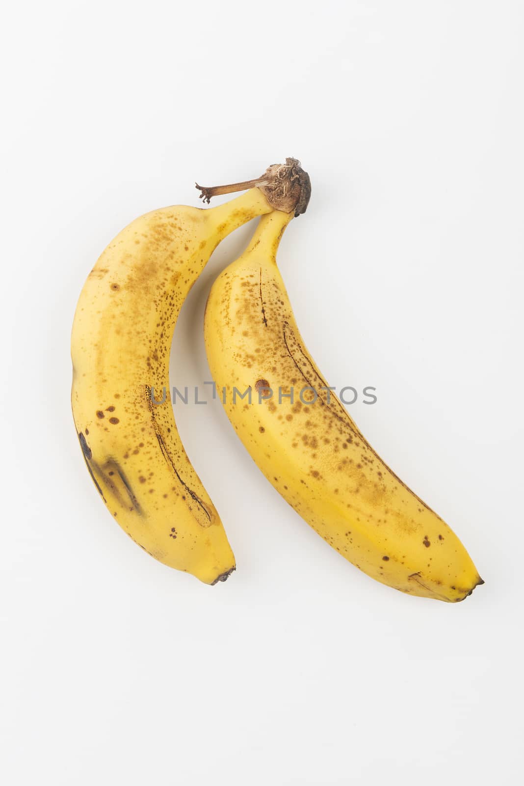 two bananas on a white table