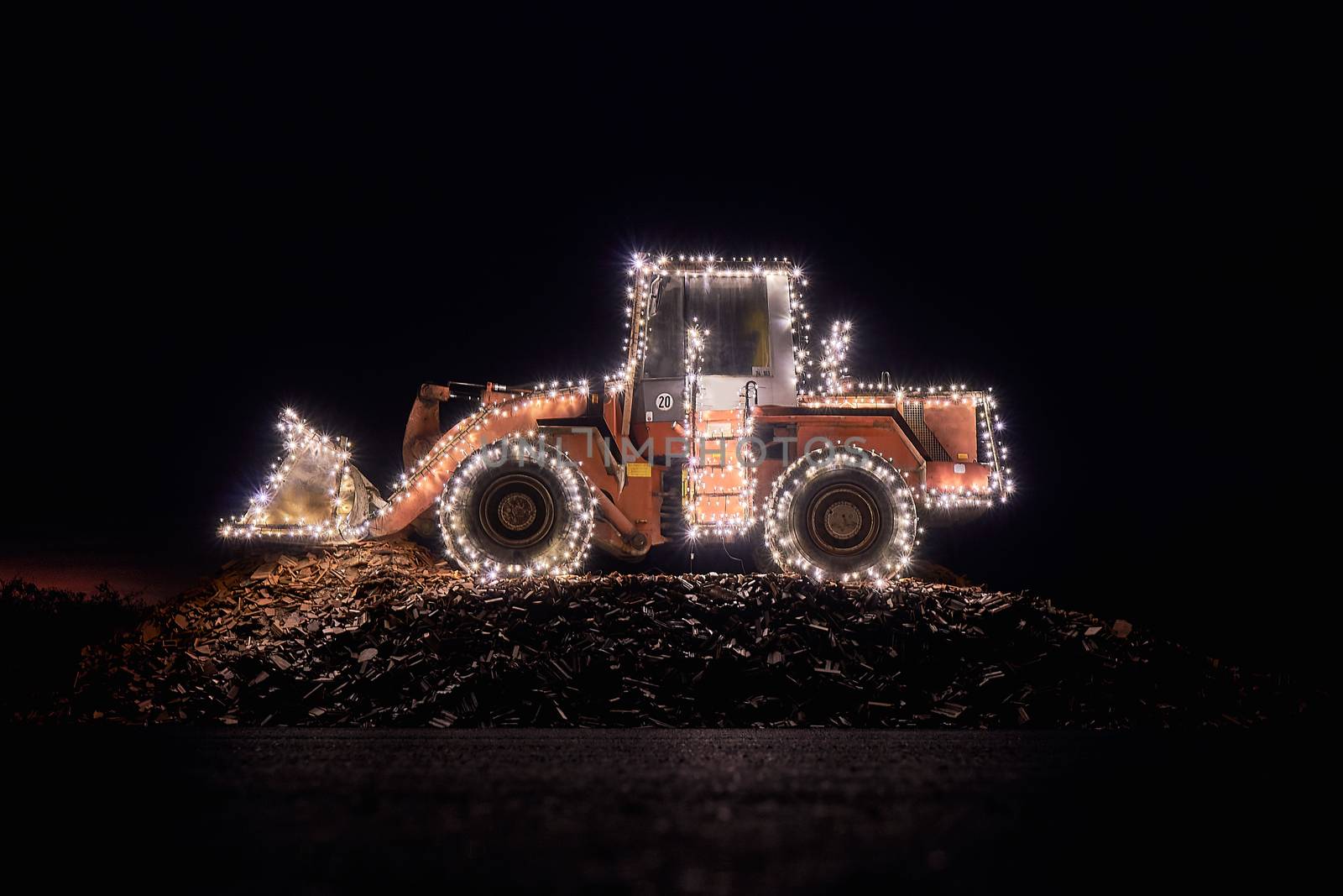 Blurred wheel loader decorated with lights bokeh