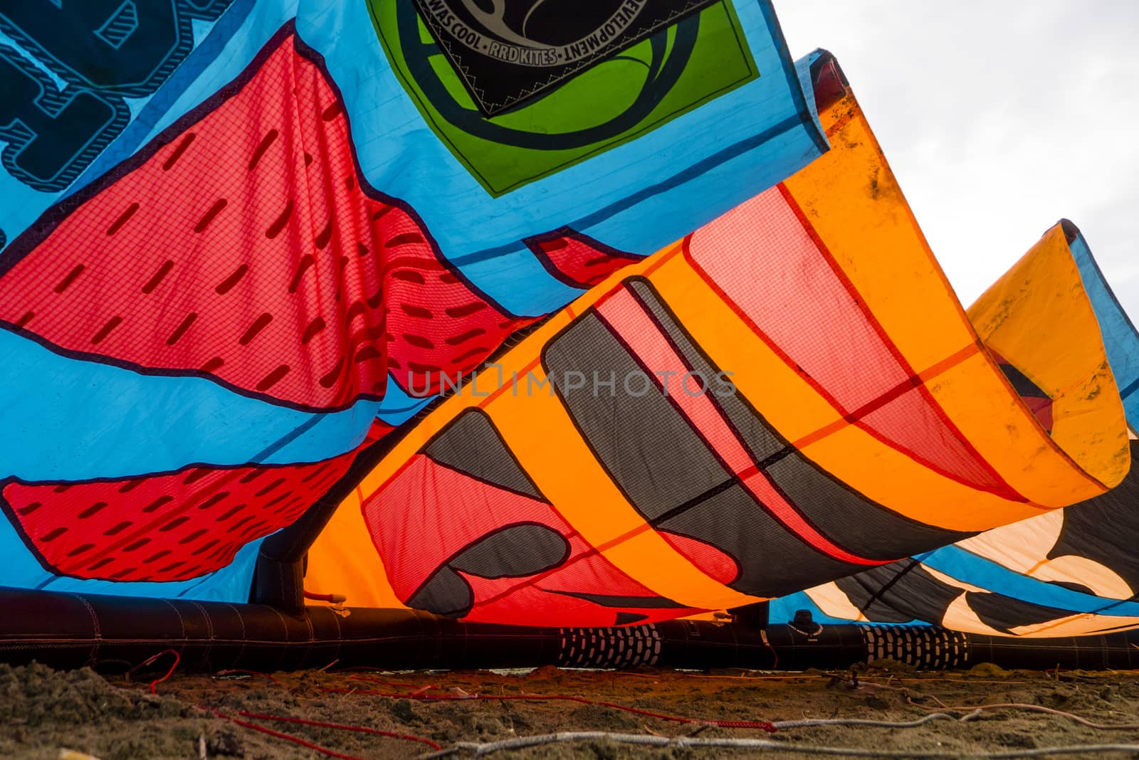 Kite surfing on Mediterranean sea in Winter with cloudy sky.