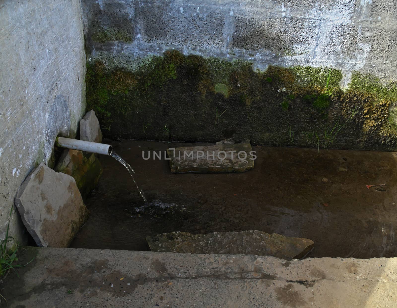 Simple fountain flowing with clear mountain water