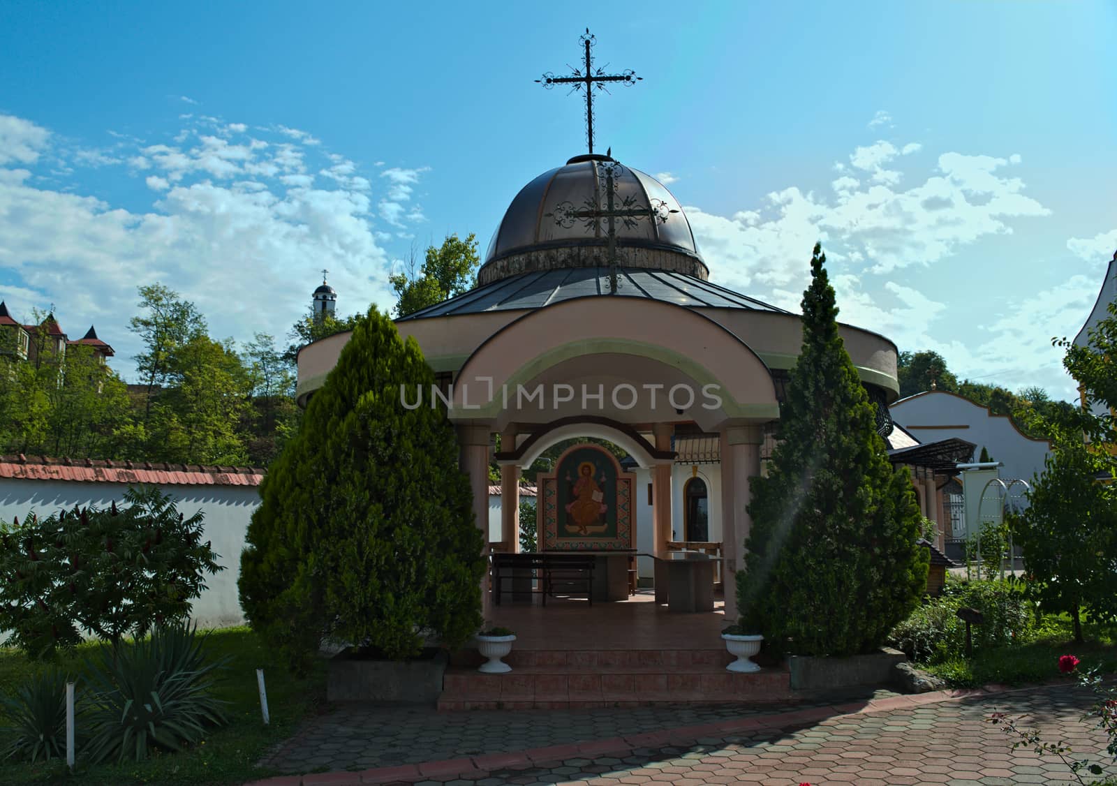 Small open chapel and decorative plants around it