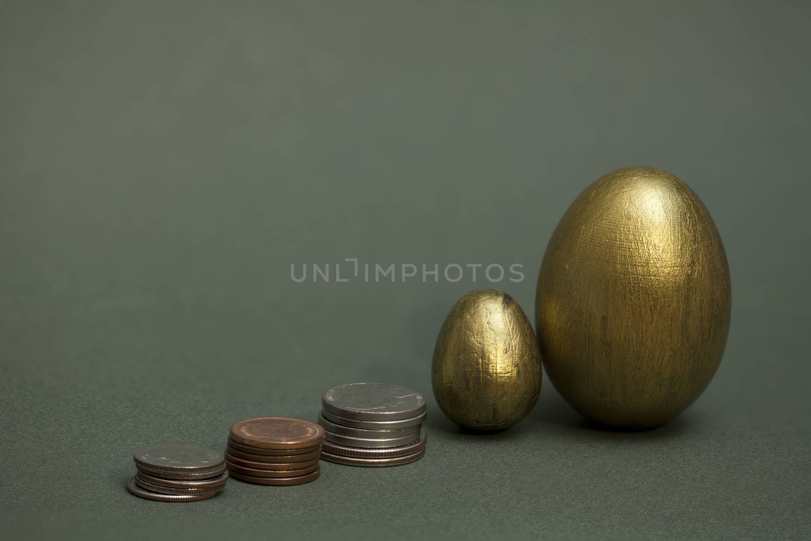 coins pile up and golden eggs conceptual image of investment income, savings retirement savings. copy space