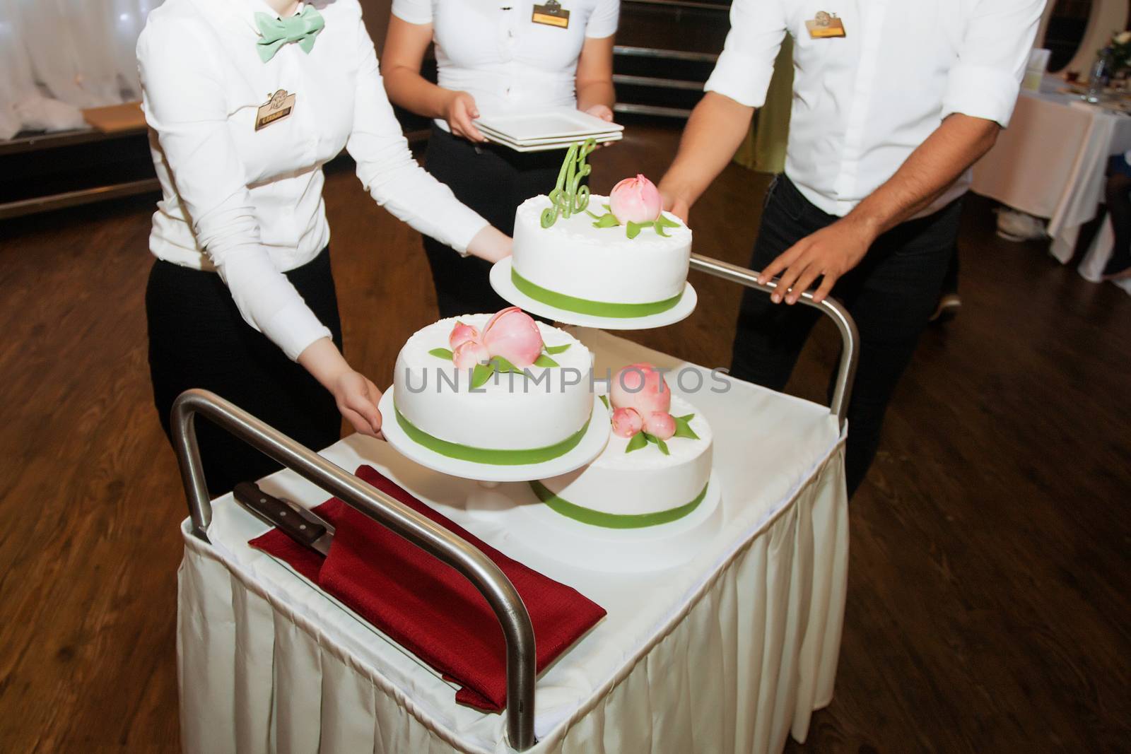 elegant pretty young bride and groom cut the wedding cake by 3KStudio