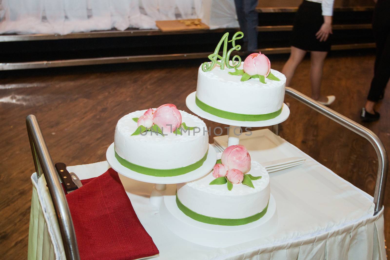 elegant pretty young bride and groom cut the wedding cake by 3KStudio