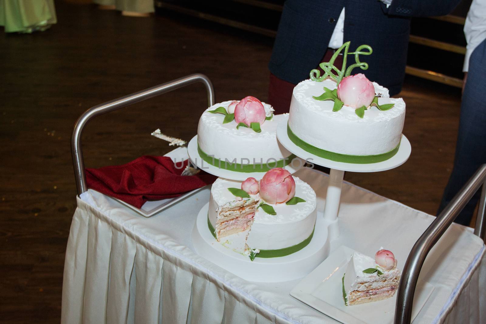 elegant pretty young bride and groom cut the wedding cake.