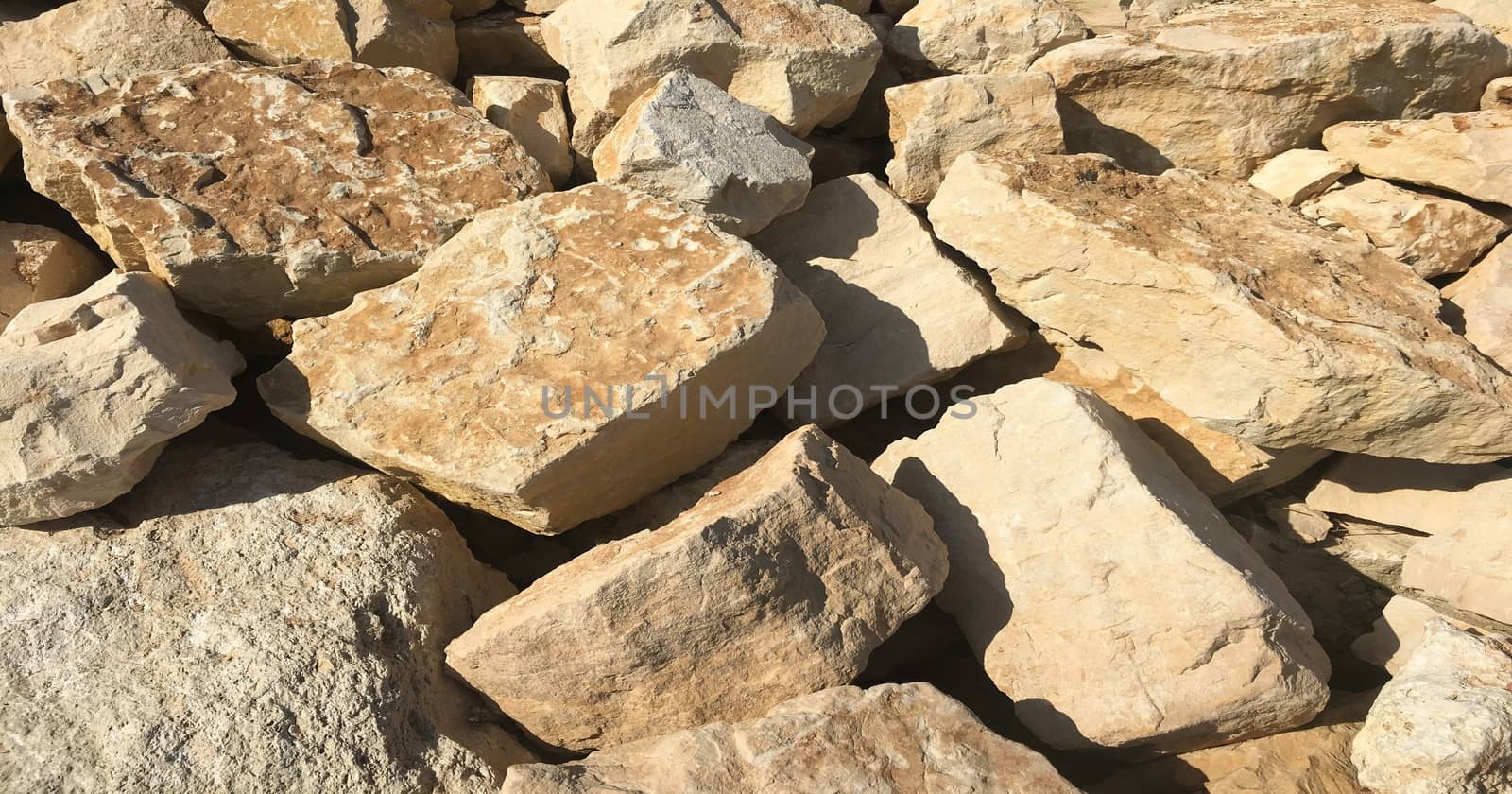 Old beige stone wall background texture close up, wall stone. by titco