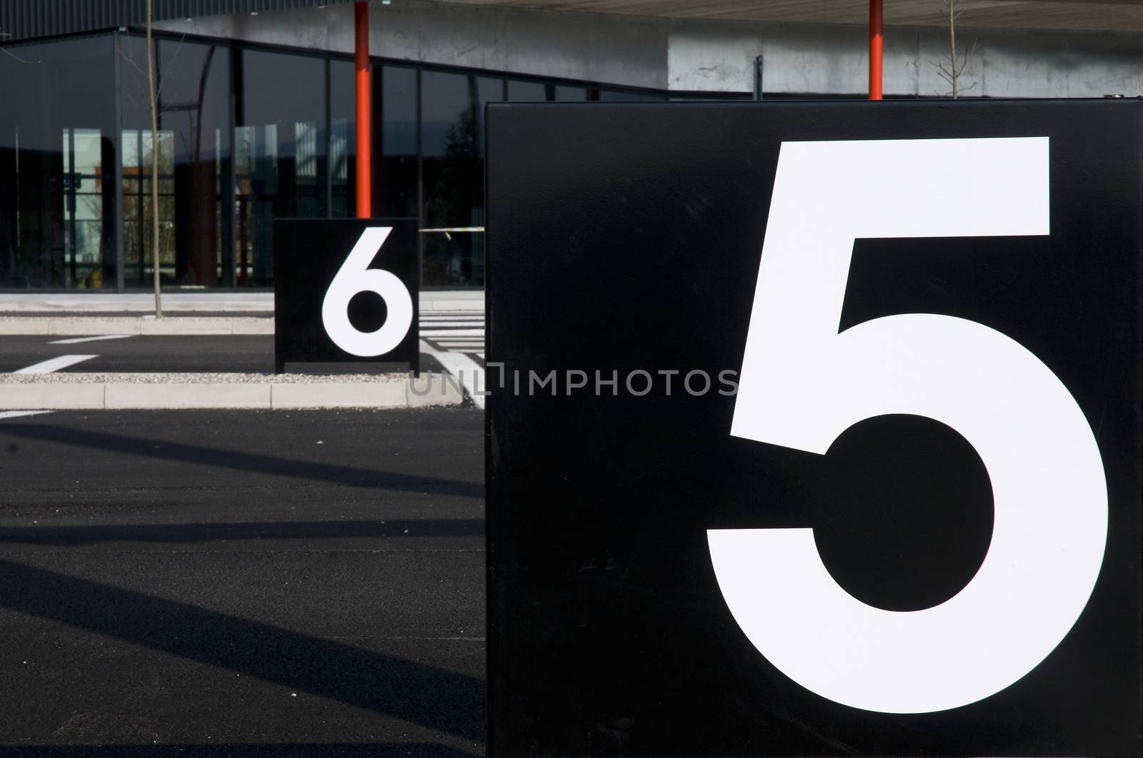 billboards with numbers in a parking lot
