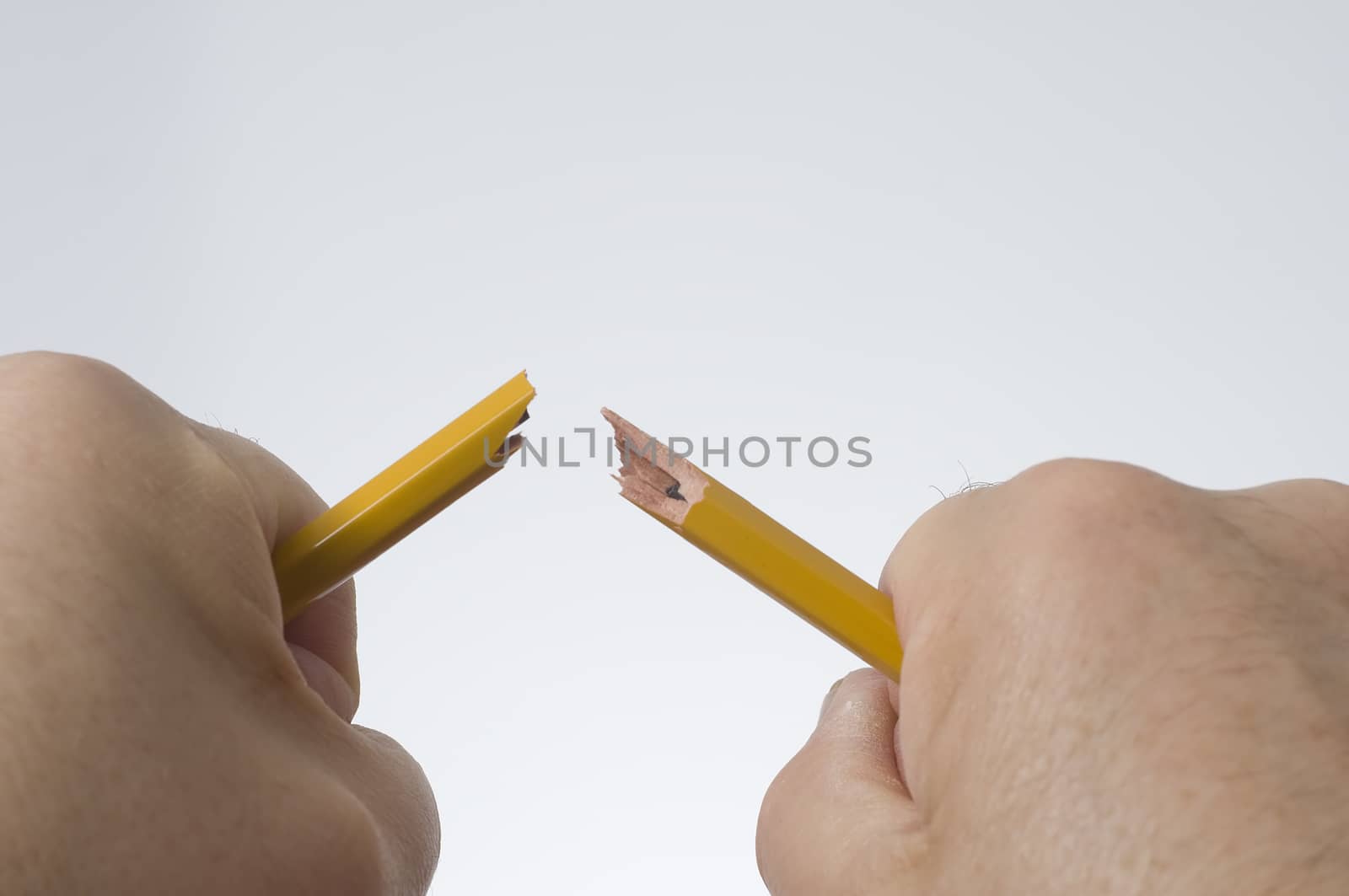 a broken pencil in his hands