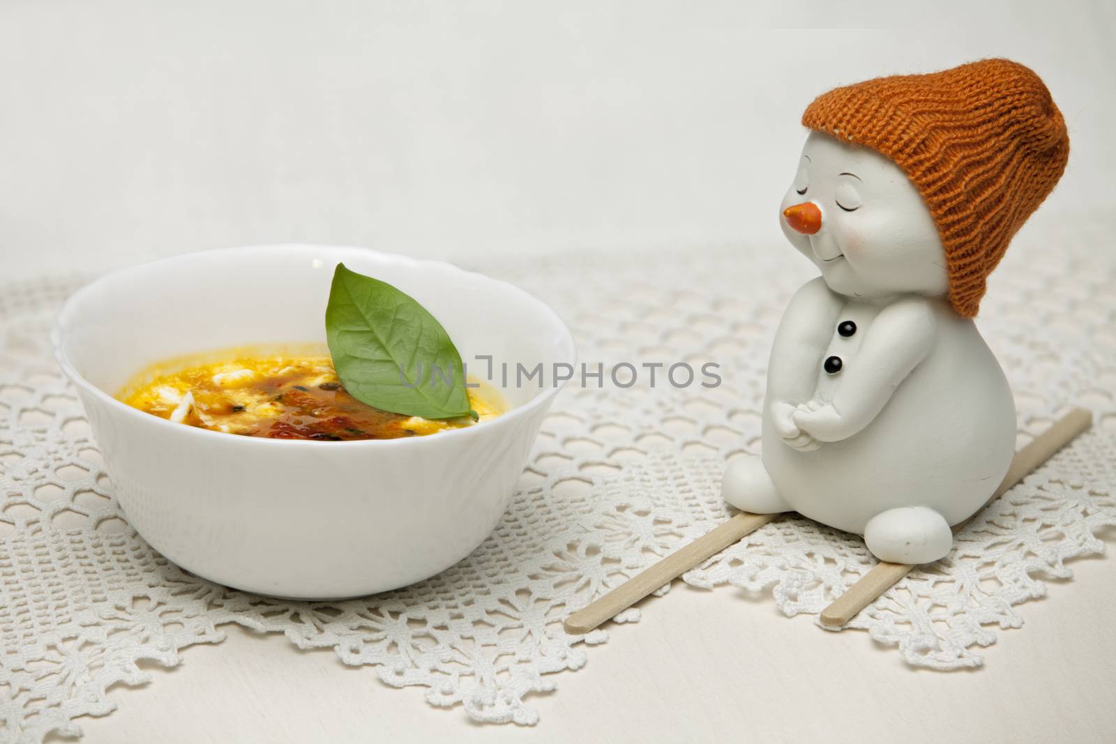 Ice cream with berries of sea-buckthorn and snowman skier tasty and healthy dessert with vitamins