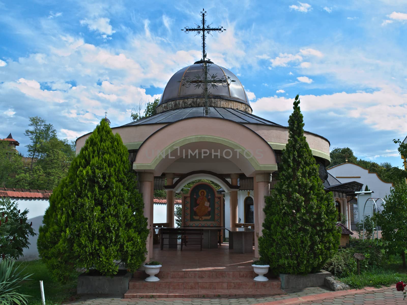 Small open chapel and decorative plants at Serbian Monastery