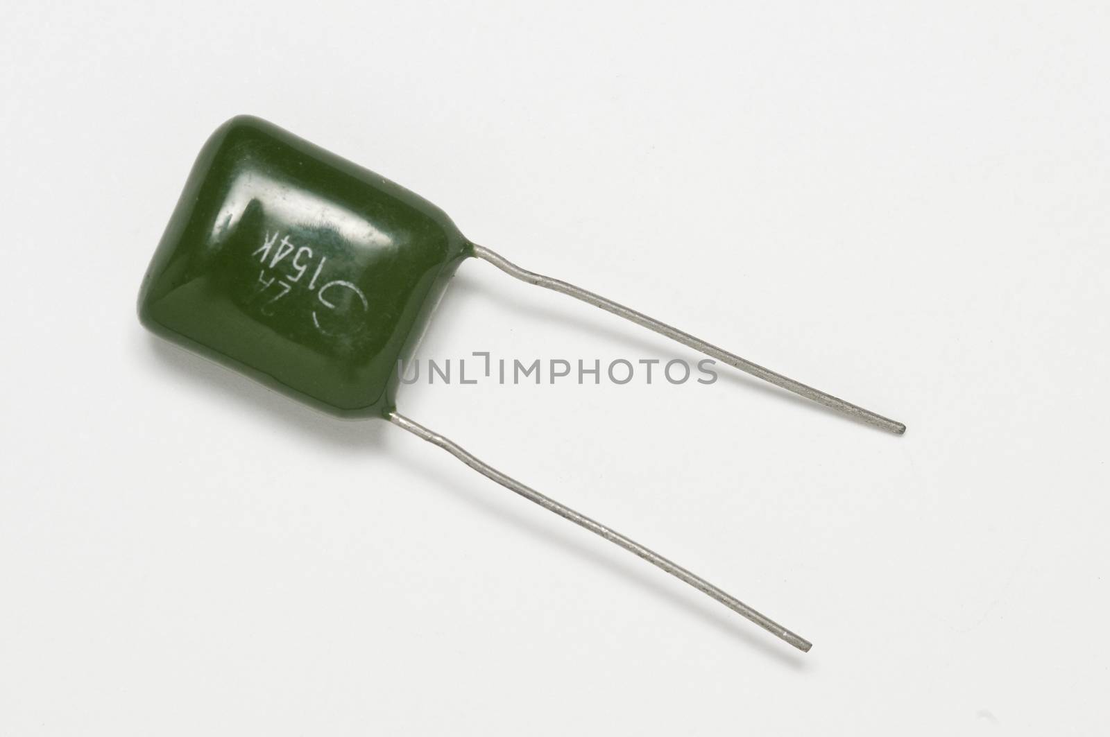 old colored capacitor on a white surface