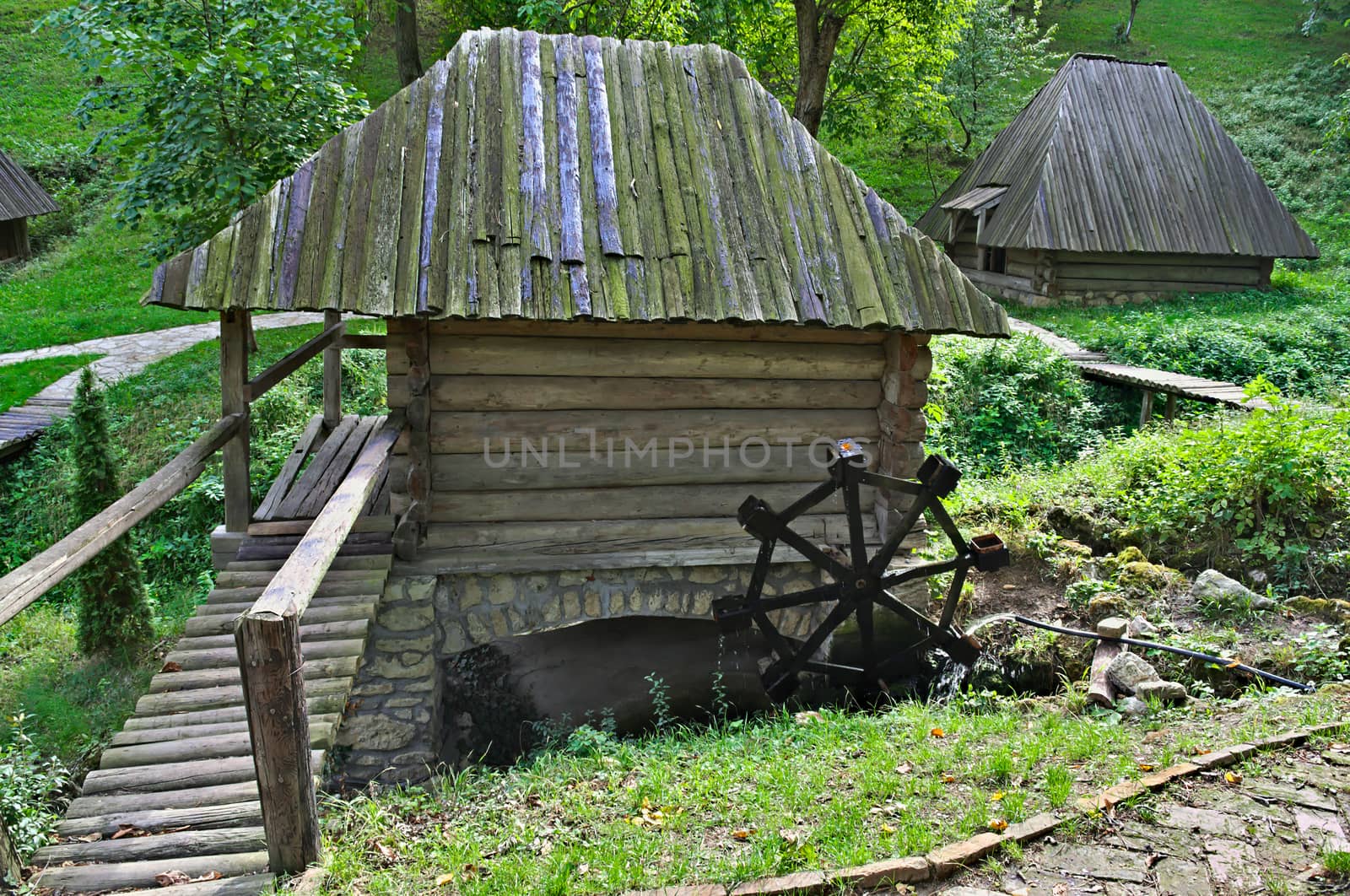 Old style wooden water mill in etno park