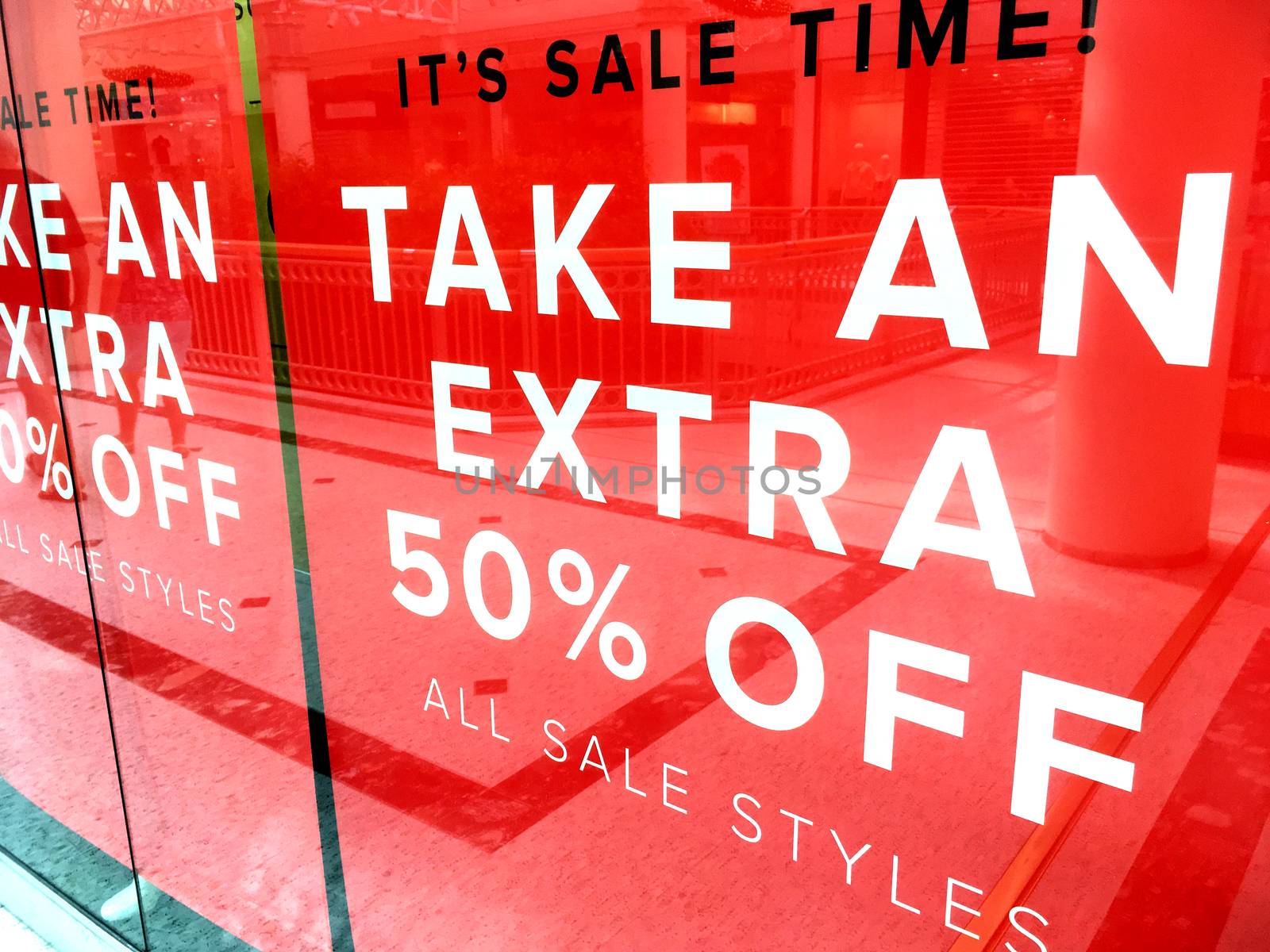 Shop front banner sign advertising a sale 50% off 