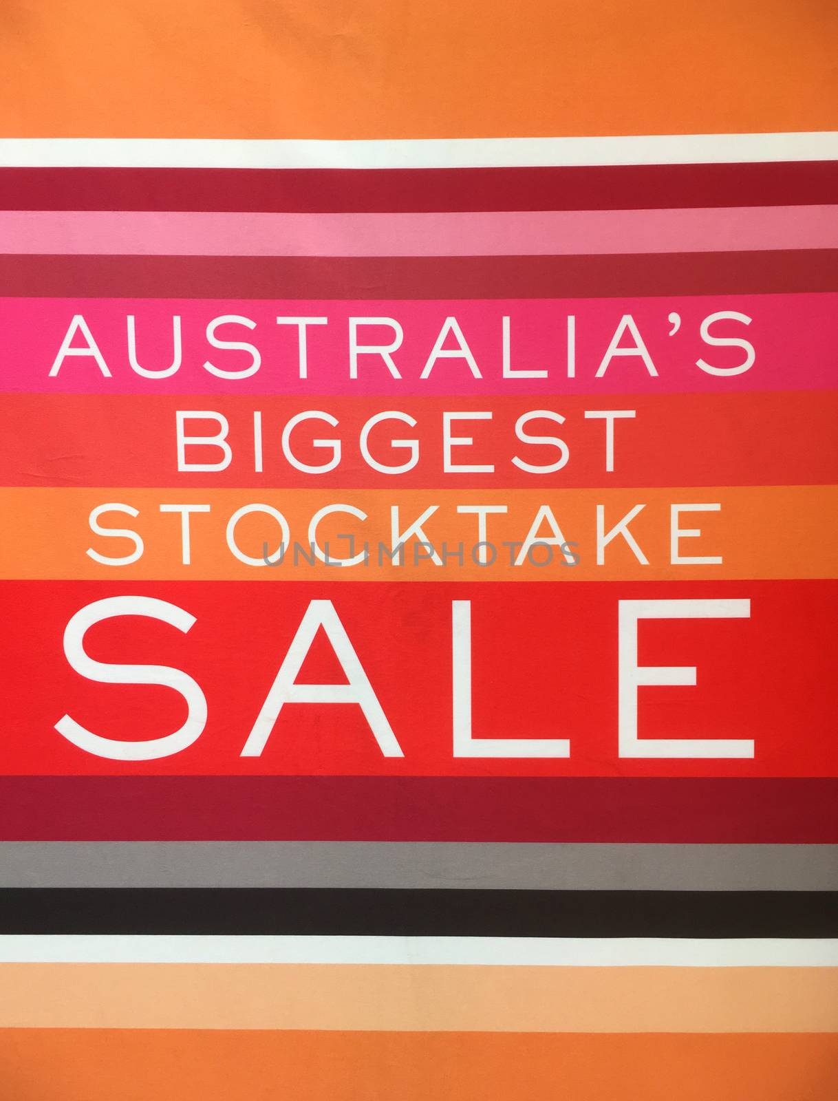 Stocktake sale sign banner hanging in a shop window