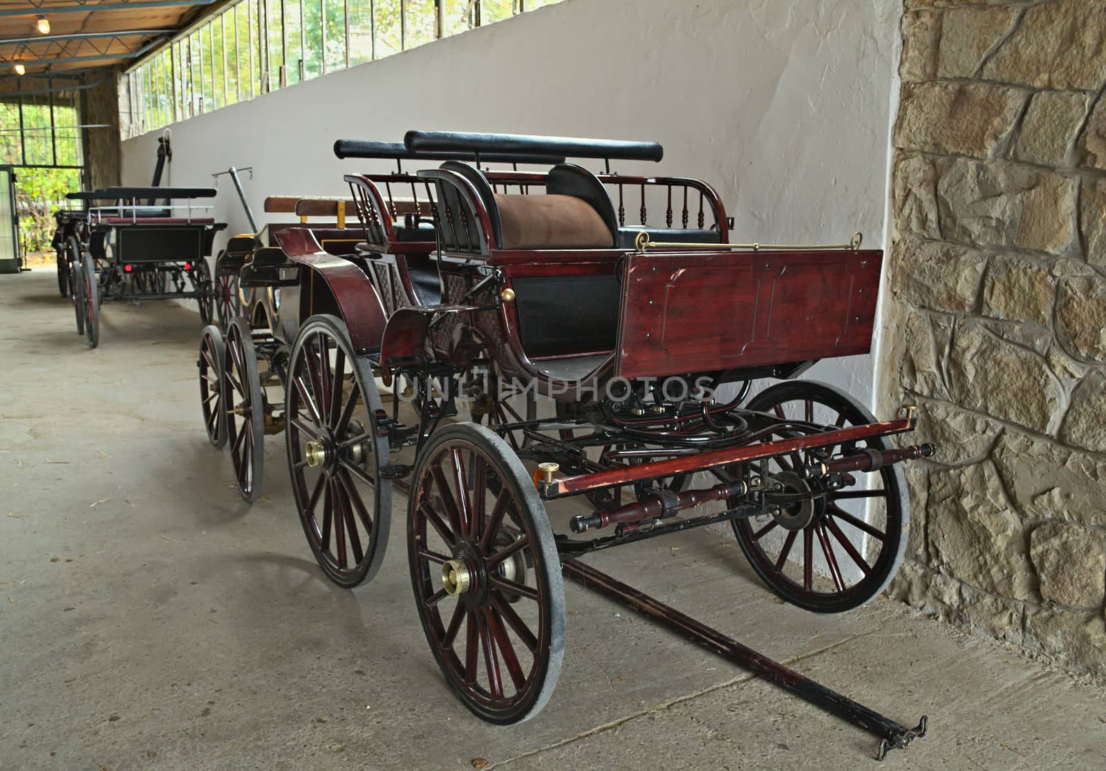 Vintage old style chariots in barn by sheriffkule