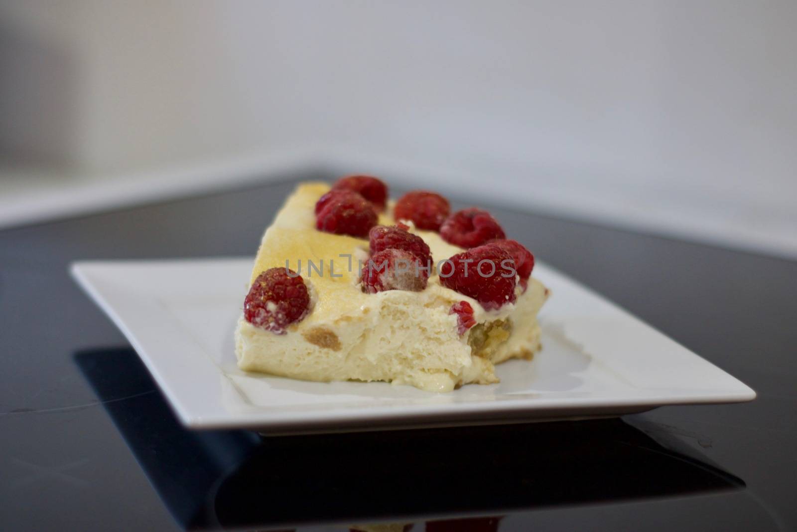 Delicious and fresh home made tiramisu with raspberry. Sweet food concept.