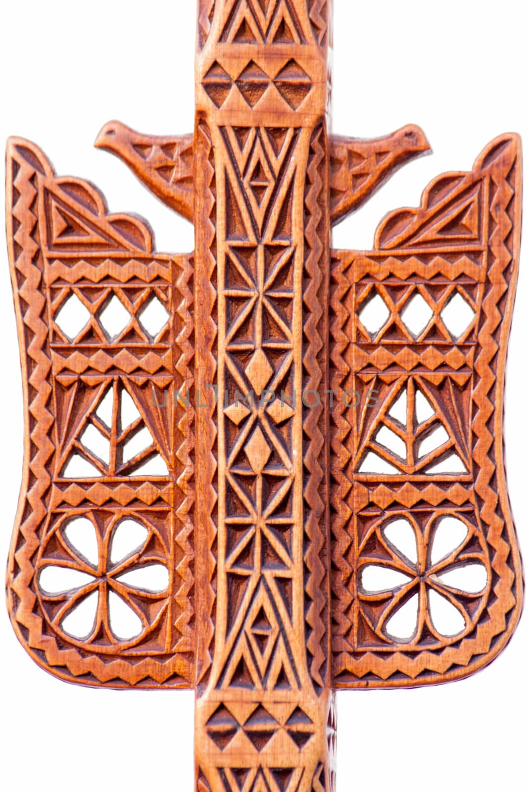 A hand-made work of art of an folk artisan carved decoration in a single piece of wood with geometric shapes and symbols for bird, flower, snake and pine-tree